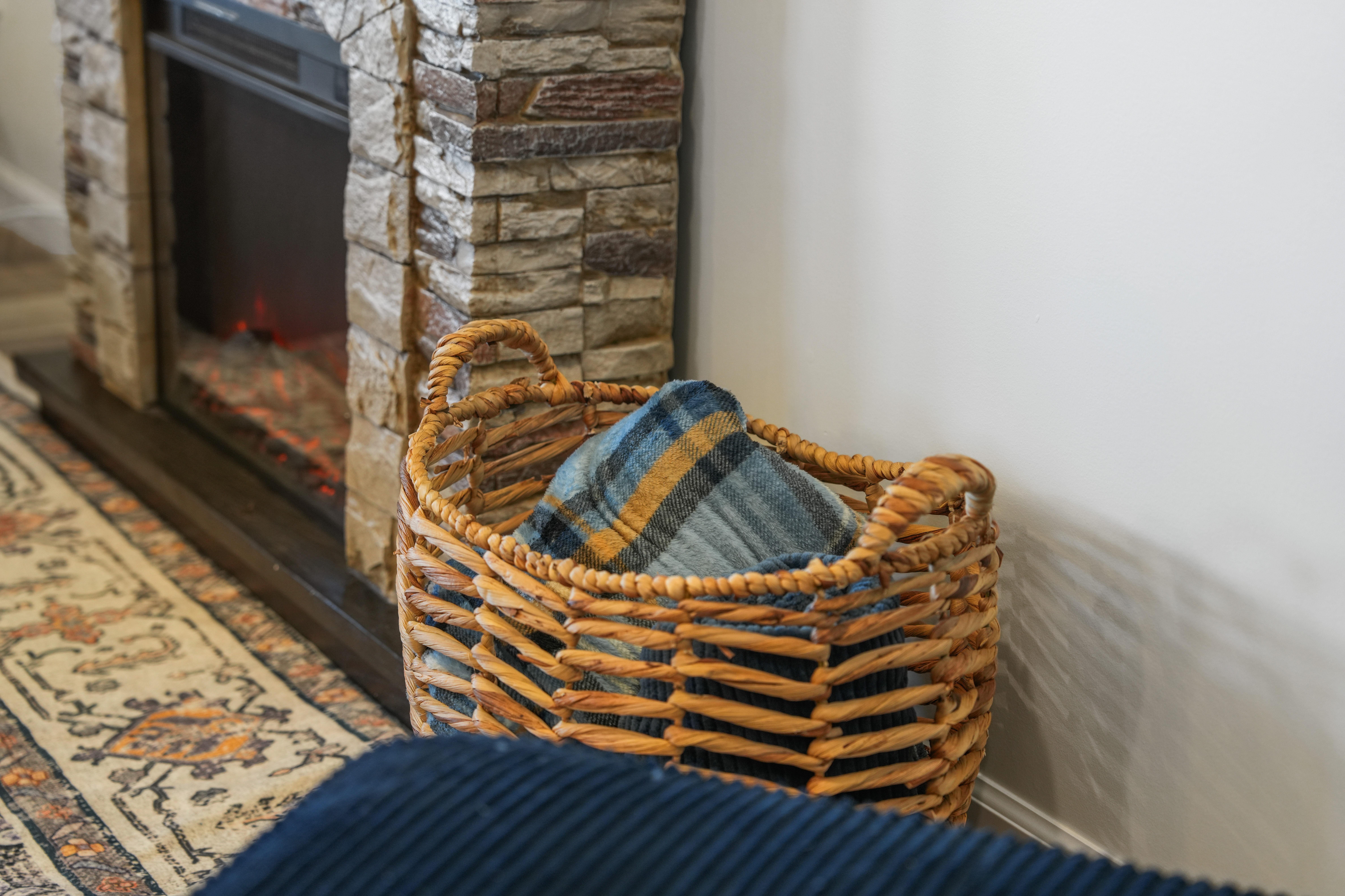 Cozy stone fireplace with soft throws for a warm, inviting stay