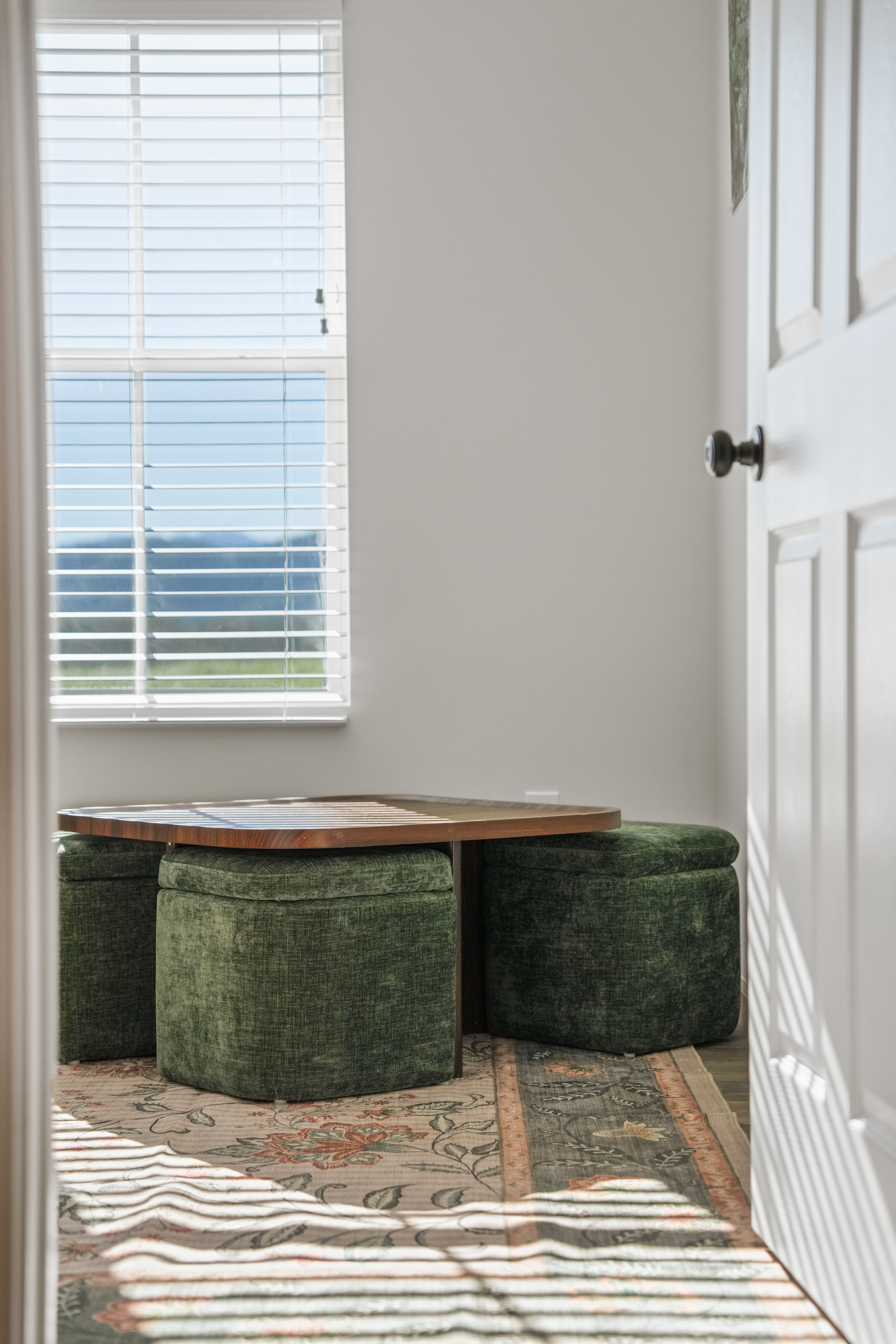 Sunny seating nook with floor poufs and a cozy low table