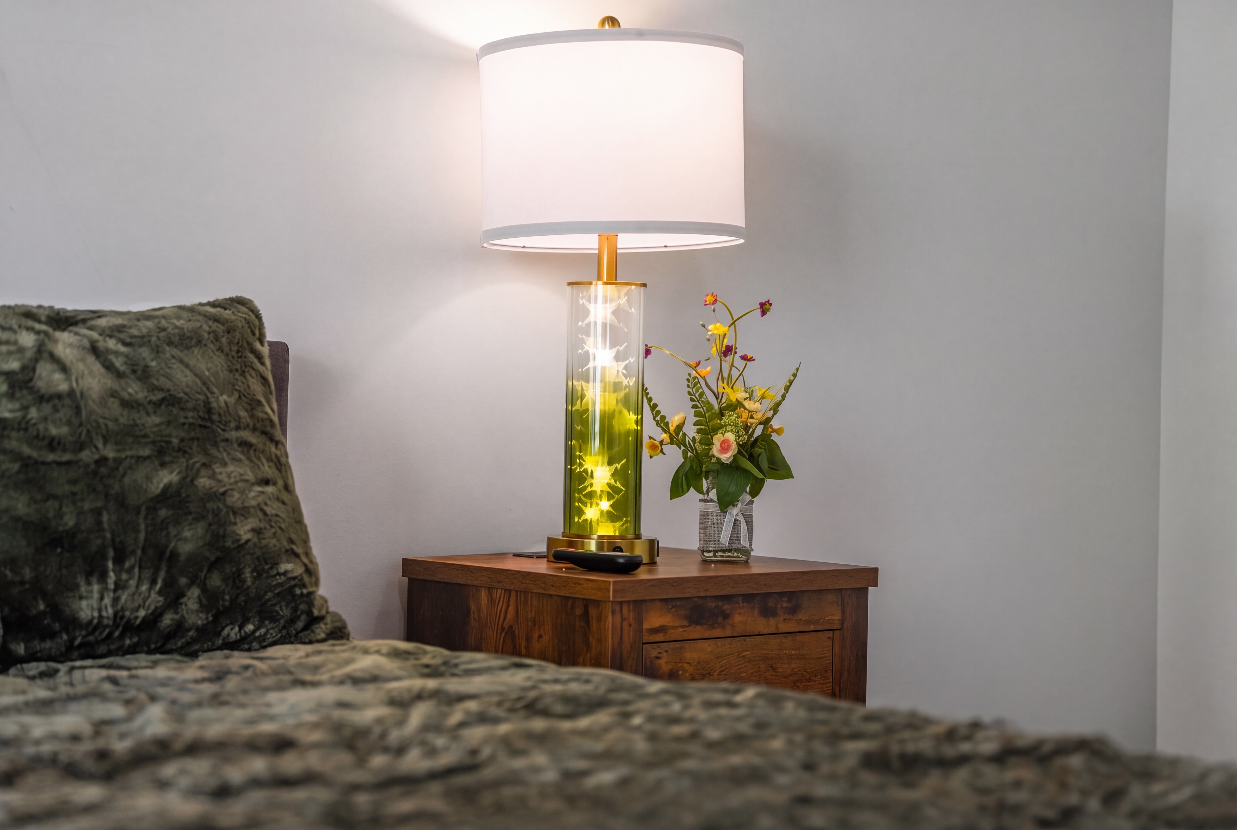 Cozy bedside nook with warm lighting, plush bedding, and elegant details