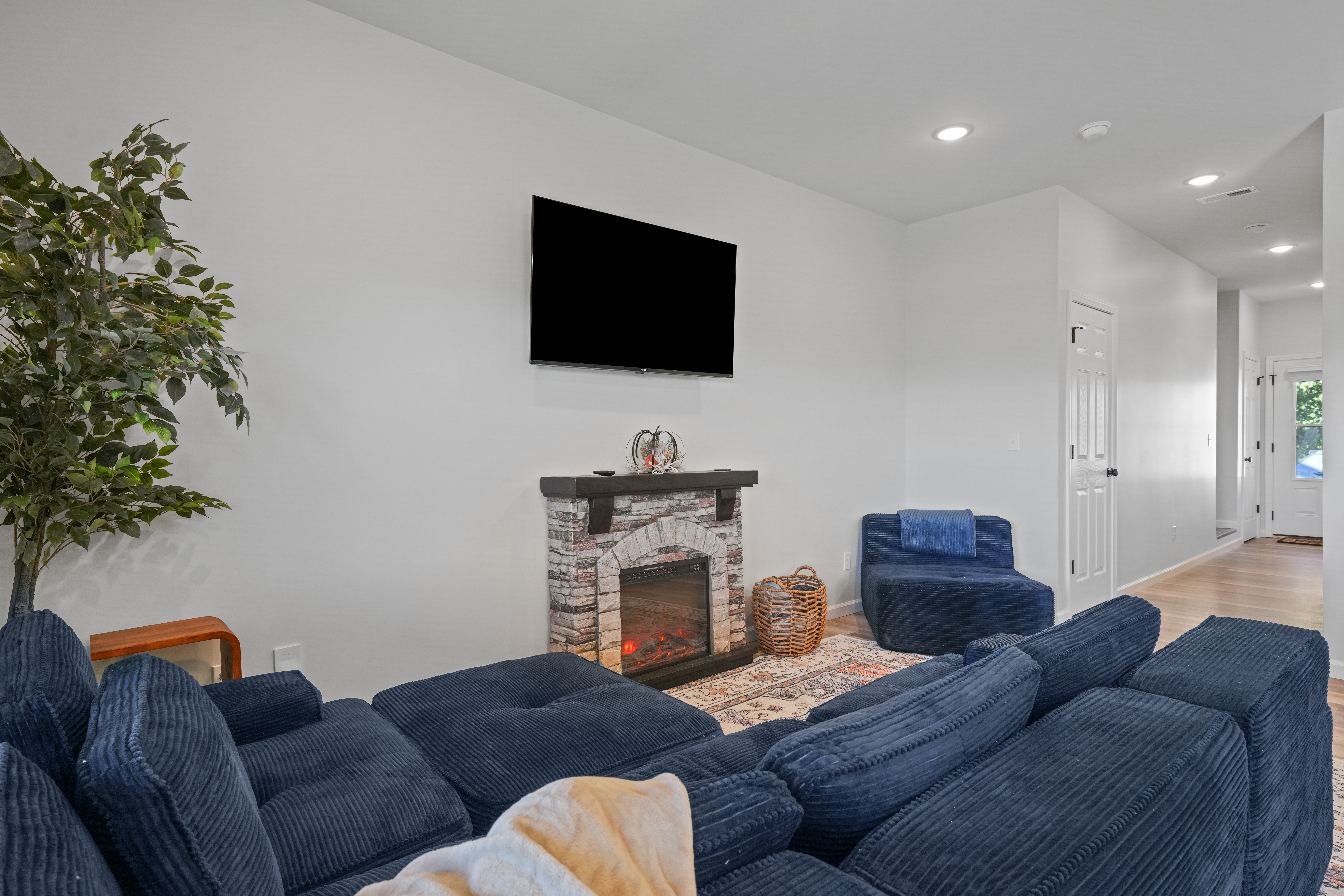 Cozy lounge with fireplace, large TV, and plush seating