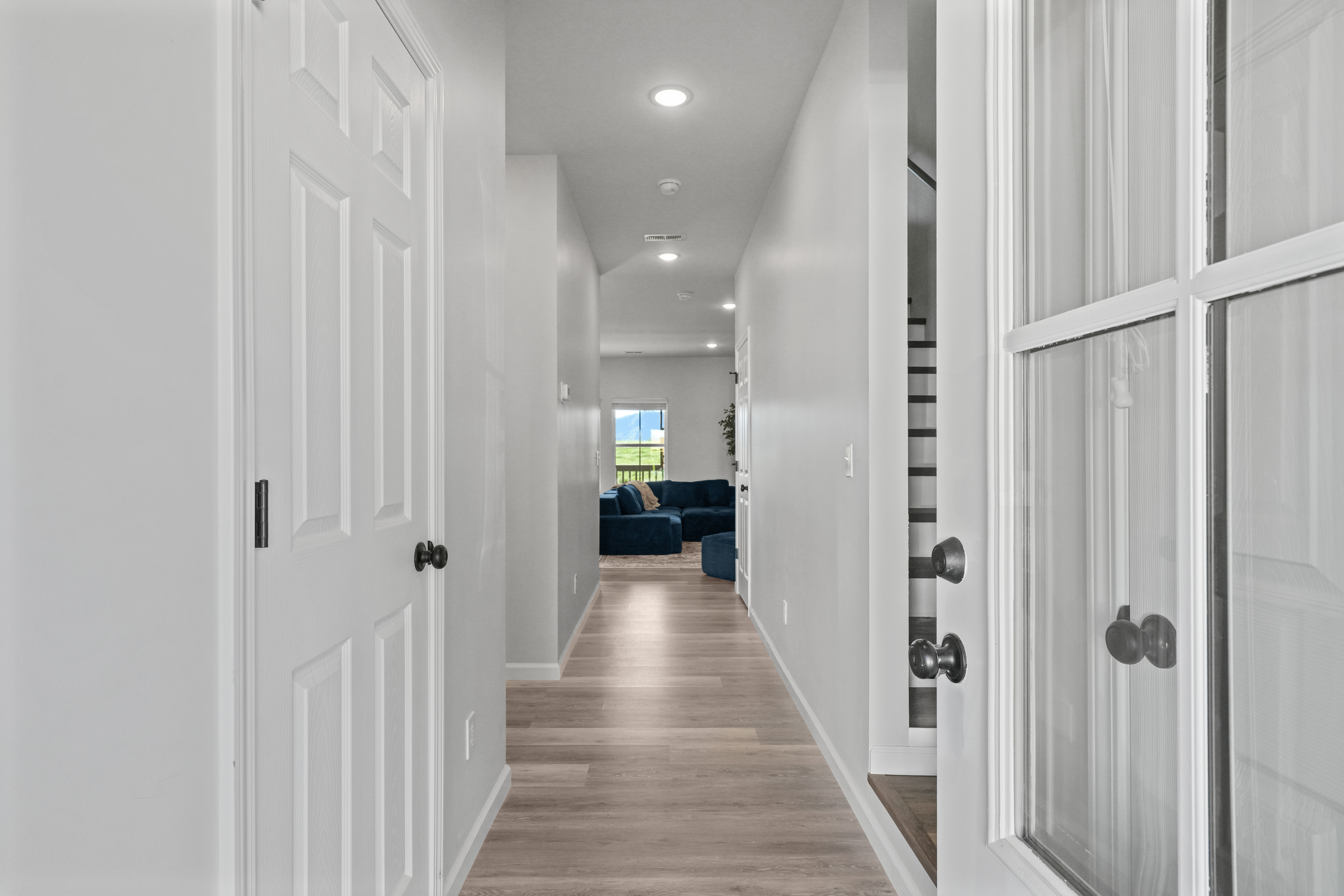 Bright modern entryway with wood-look floors and a welcoming open layout