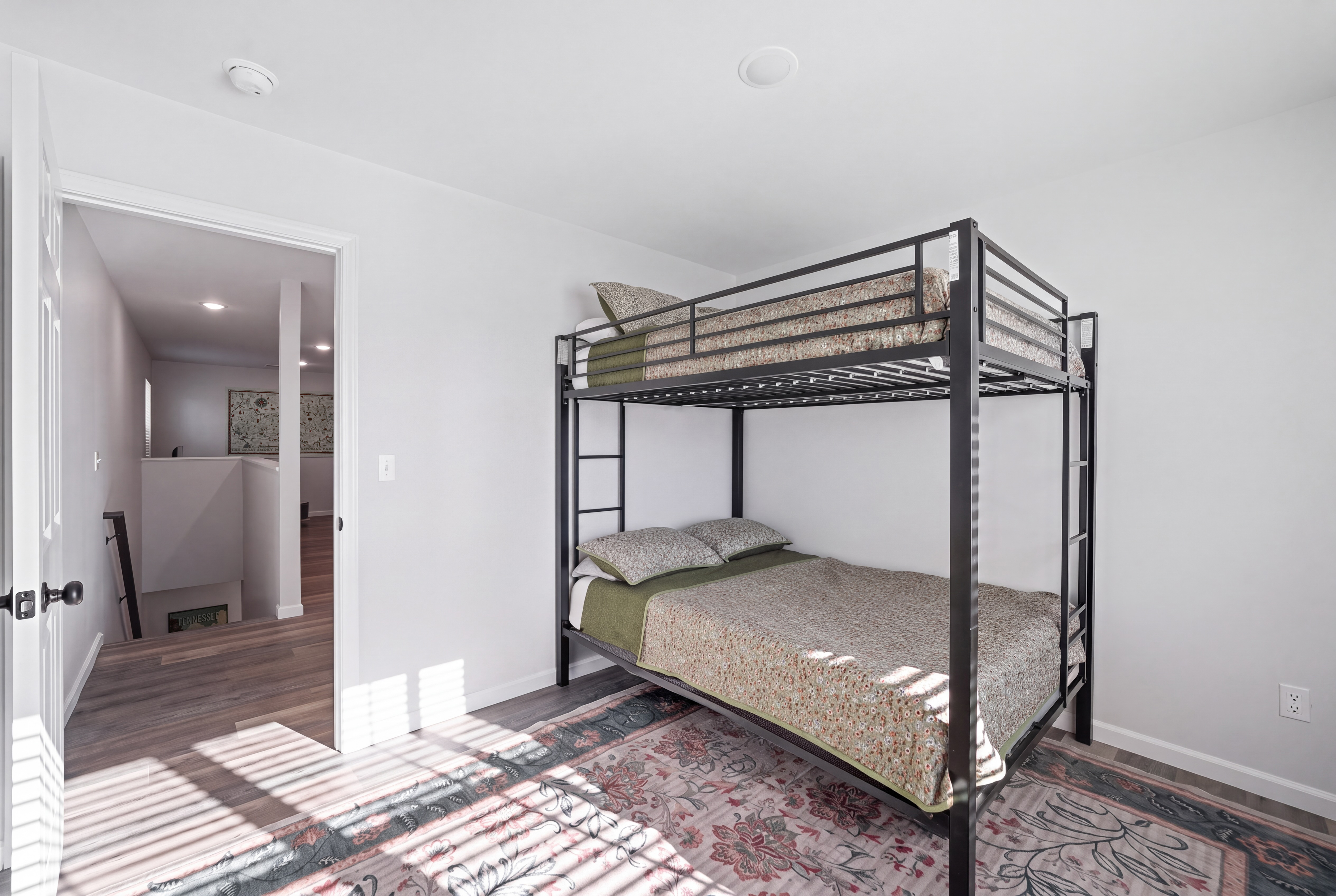 Bright bunk room with stylish rug—great for families or groups