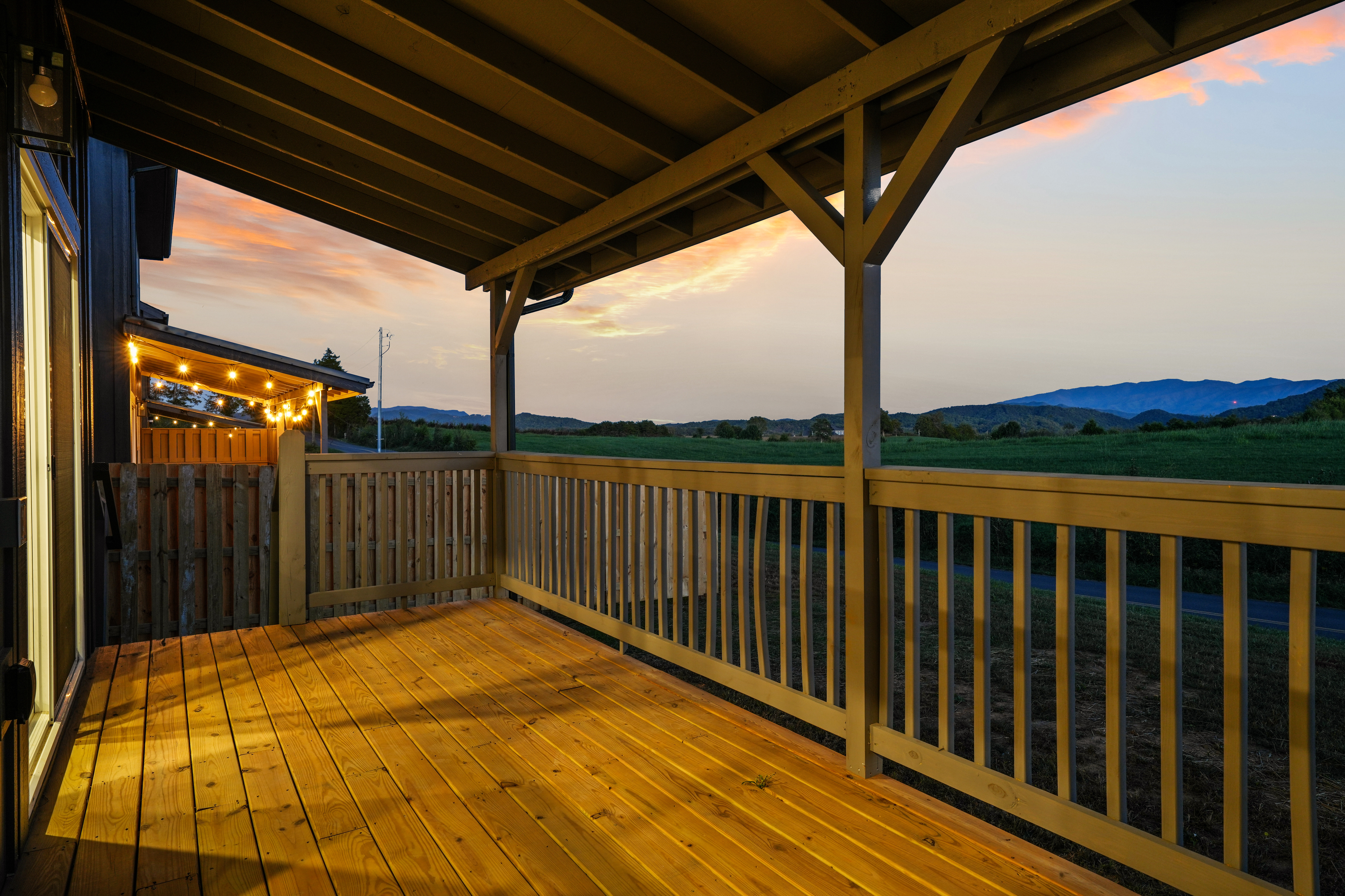 Covered sunset deck with mountain views and a warm, relaxing ambiance