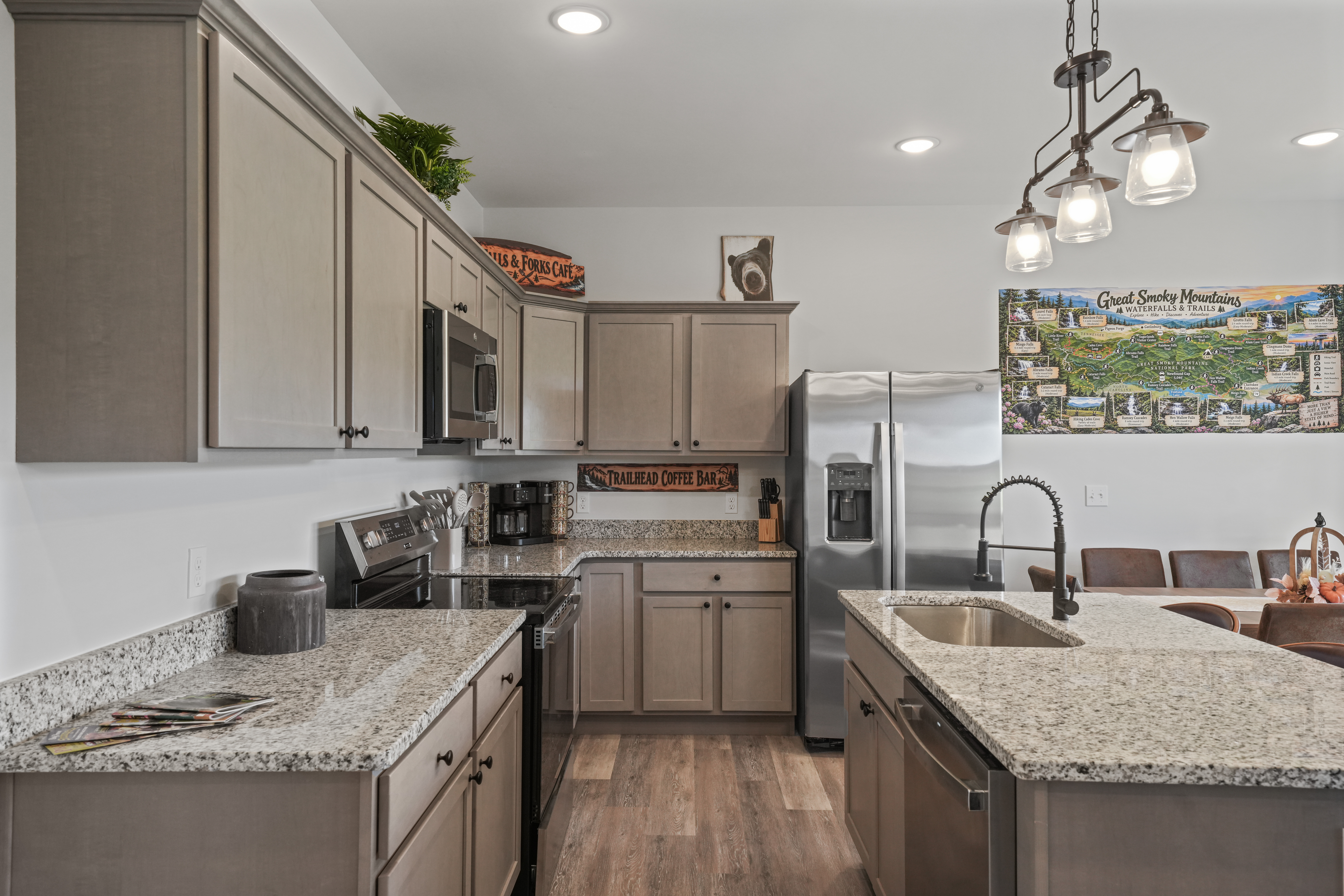 Bright modern kitchen with granite island and stainless appliances