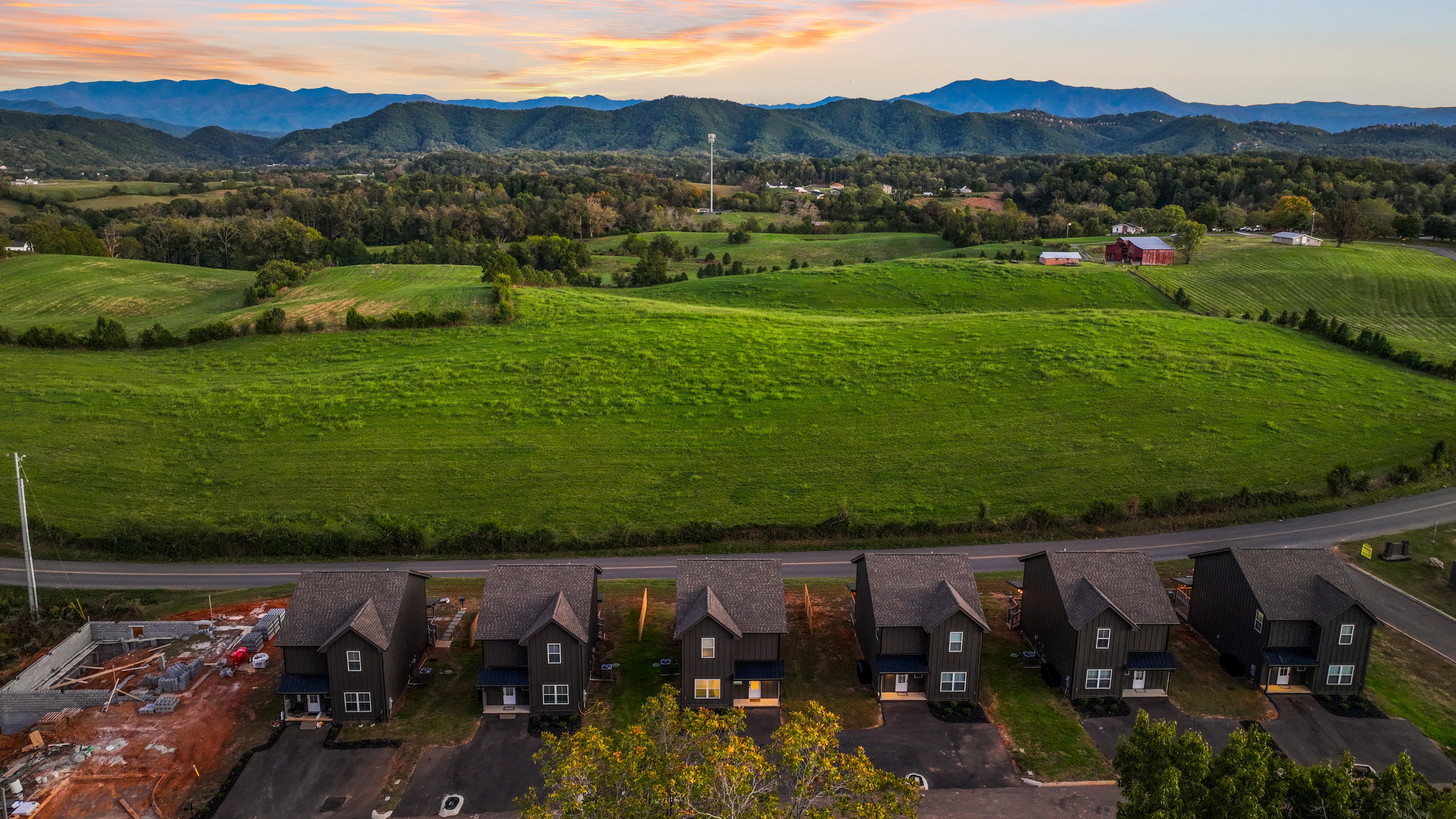 Mountain-view cabins with sweeping fields and peaceful sunset scenery