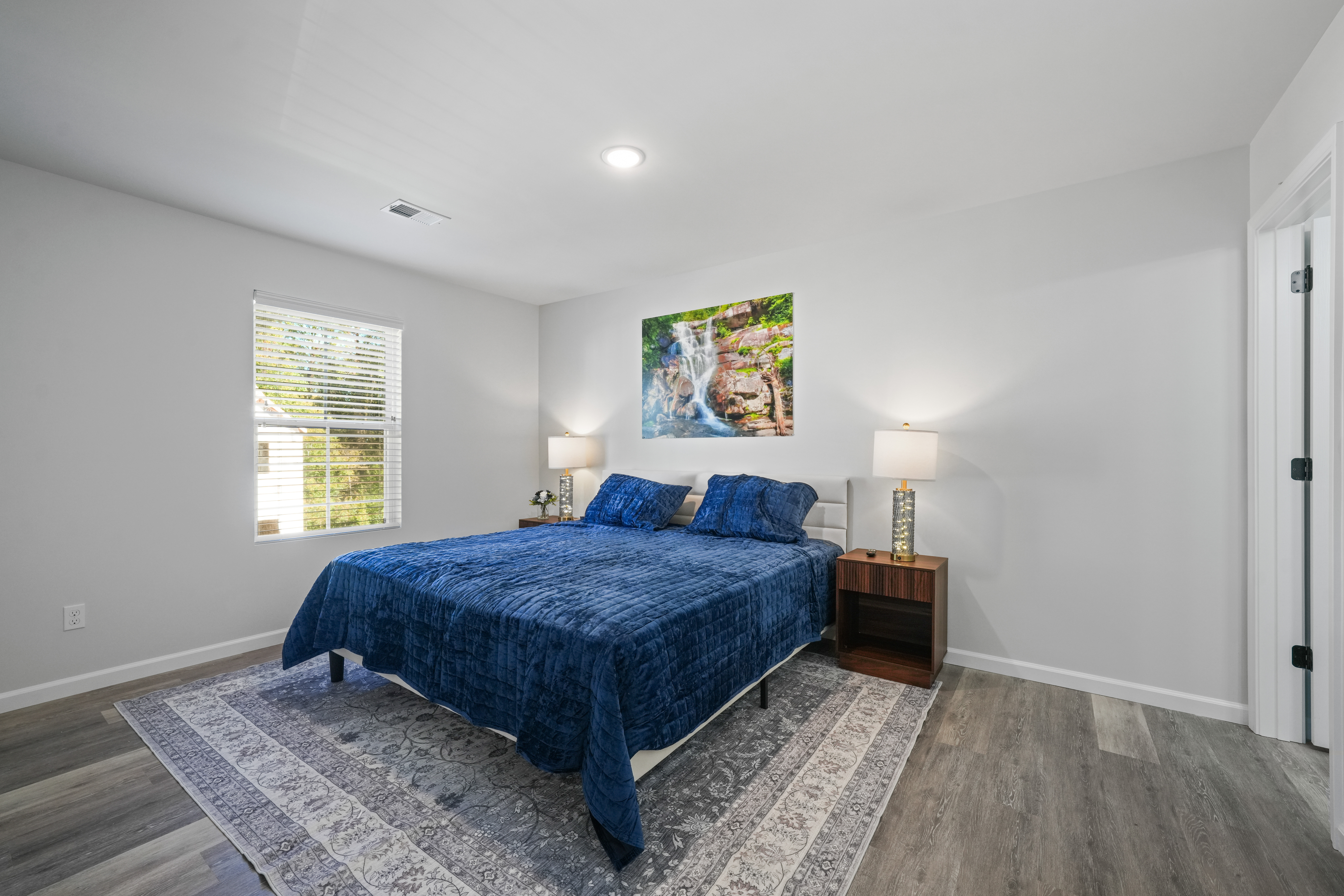 Bright, modern bedroom with plush king bed and calming natural light