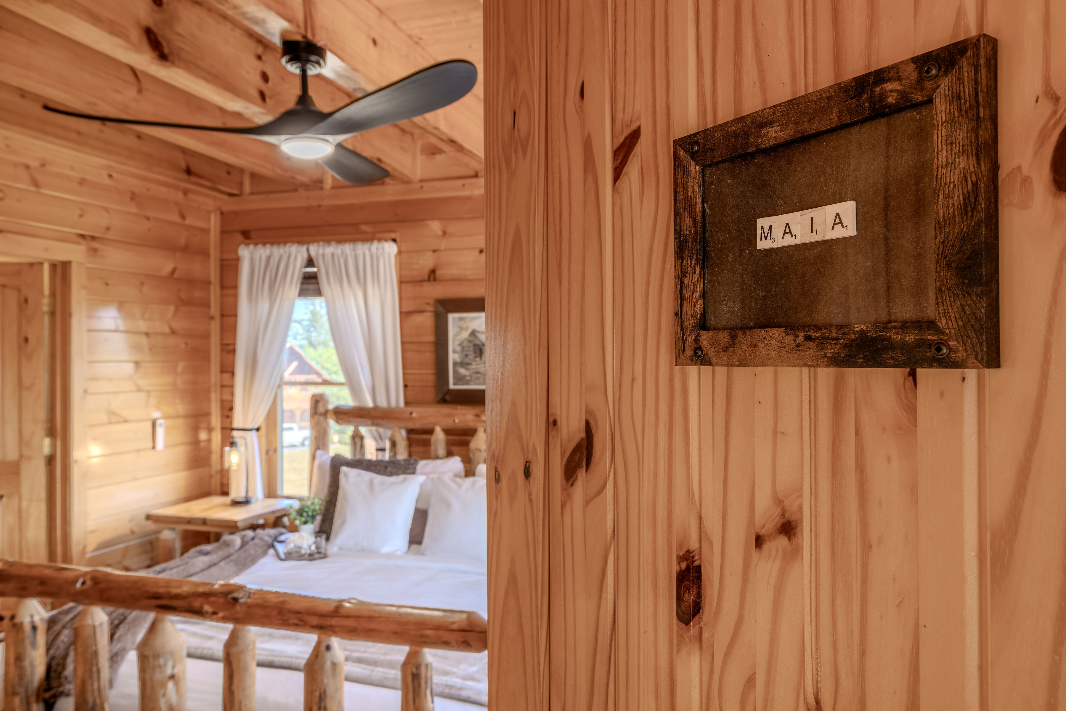 MAIA Cozy rustic cabin bedroom with warm wood interiors and inviting charm, middle floor left side off living room