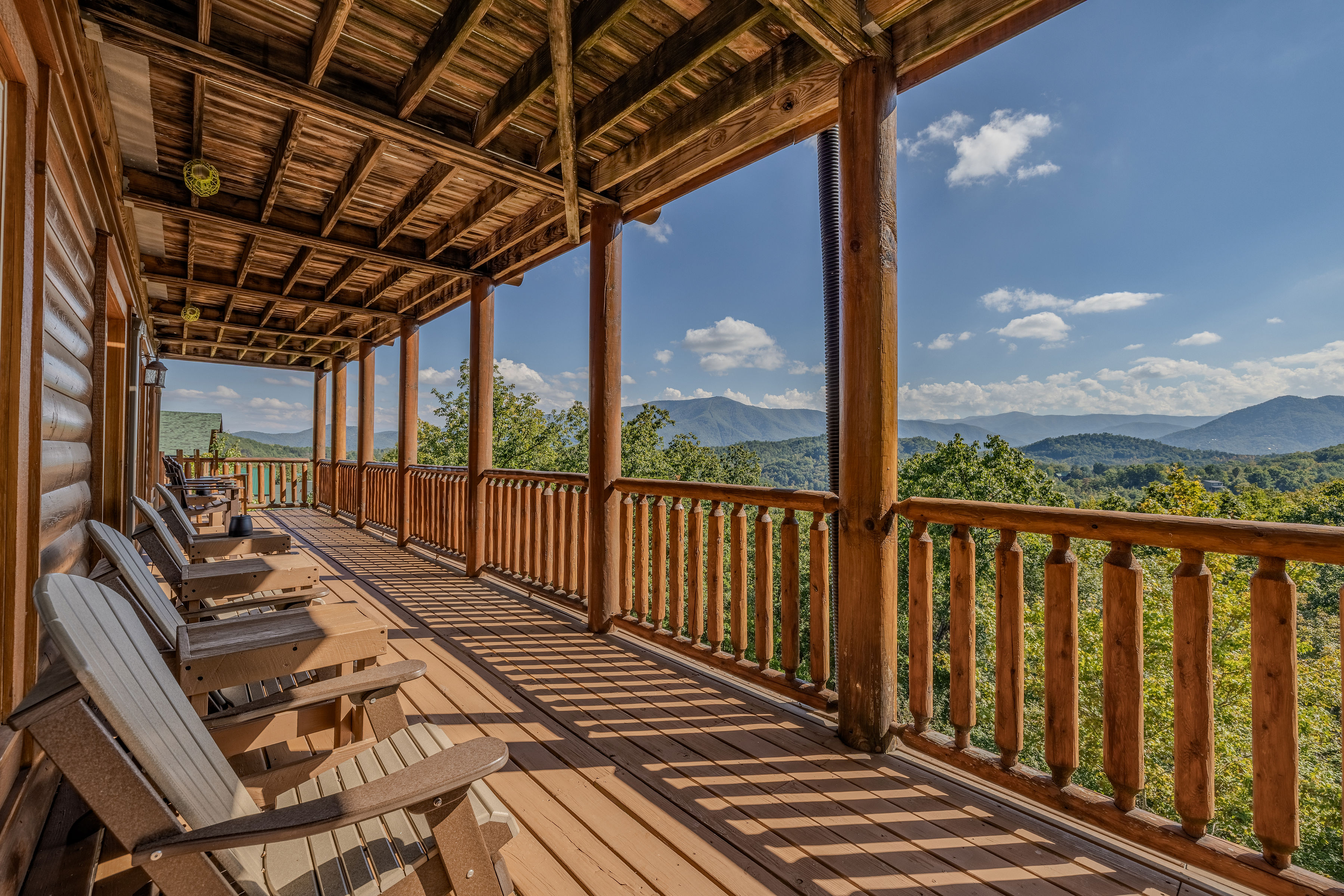 Spacious covered deck with Adirondack chairs and sweeping mountain views, Bottom Deck