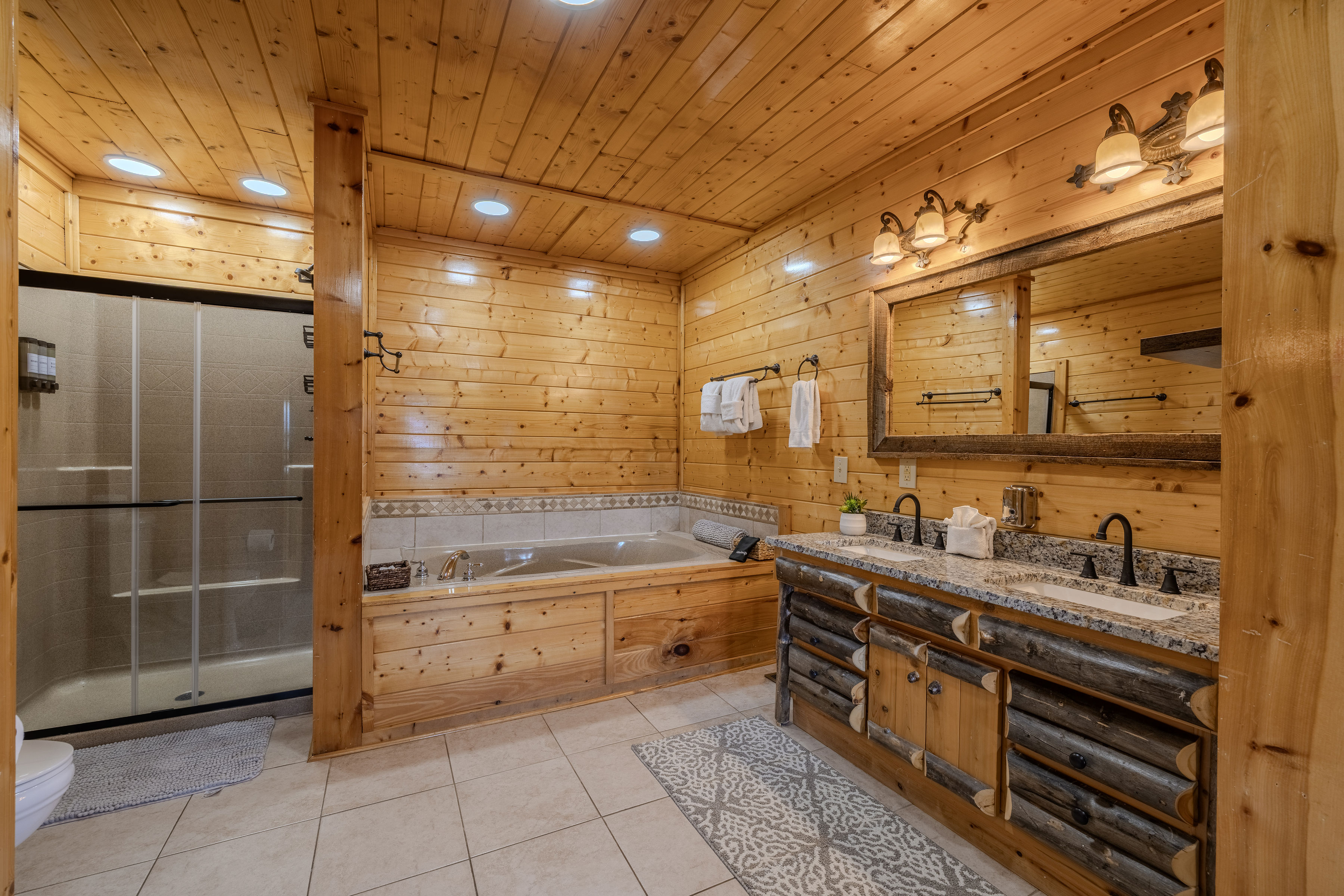 ELECTRA Rustic spa-like bathroom with soaking tub, walk-in shower, and double vanity