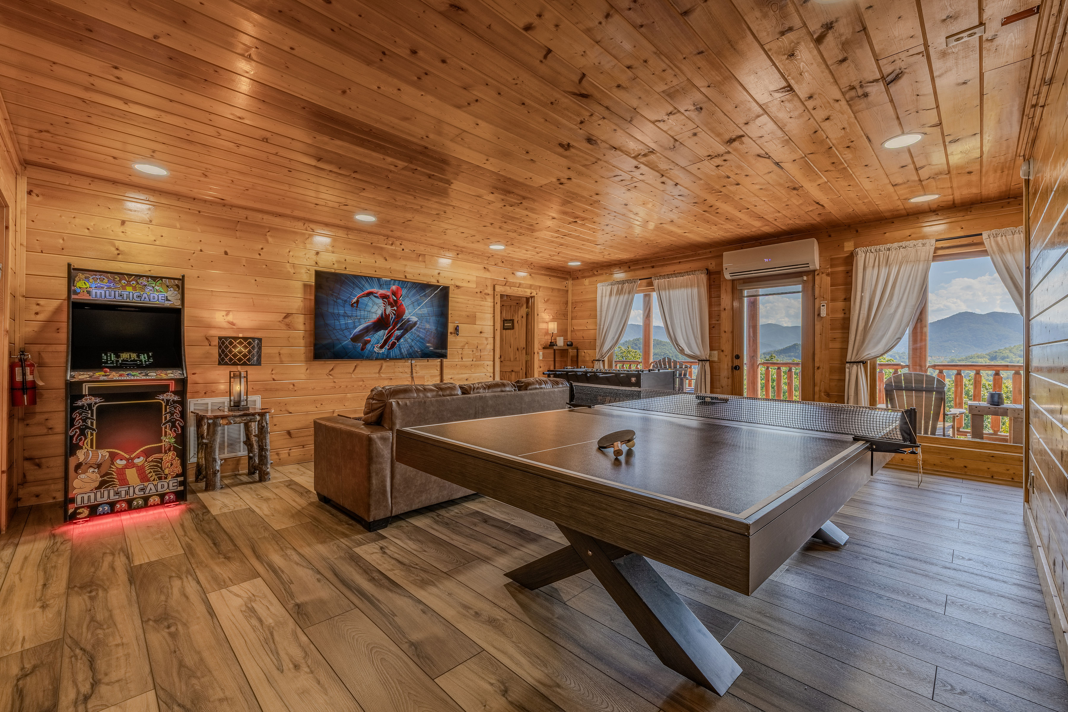 Mountain-view game room with ping pong, arcade fun, and cozy lounge seating
