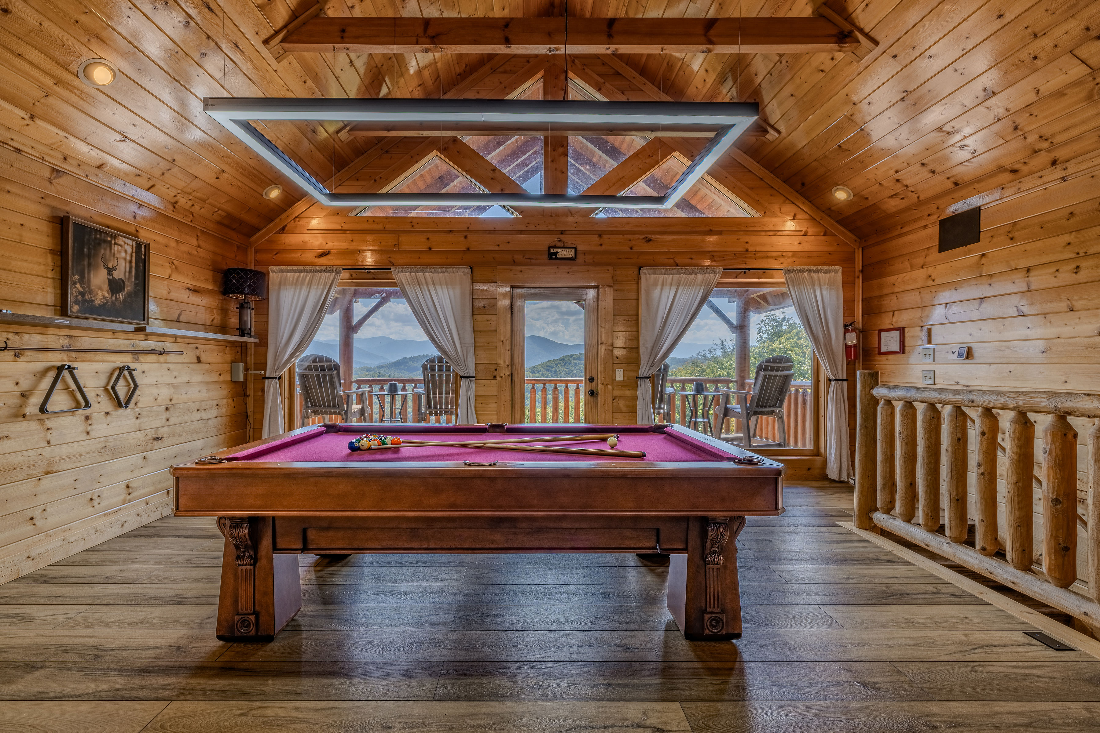 Mountain-view game room with Beech pool table, skylight, and balcony seating