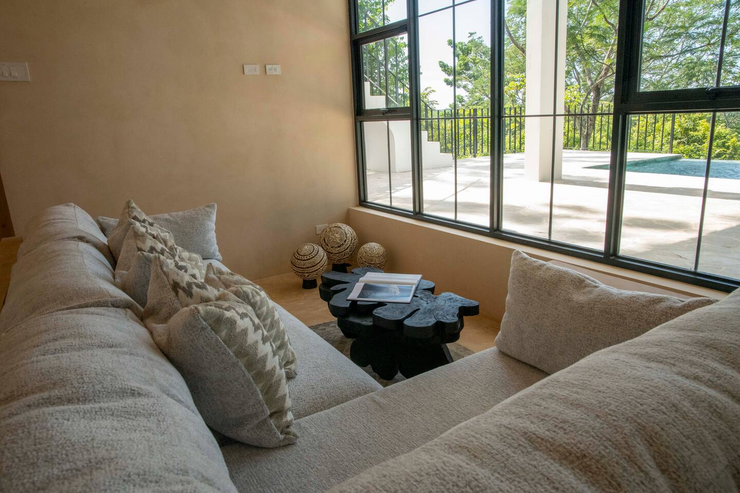 Open Living Room with beautiful pool and jungle views