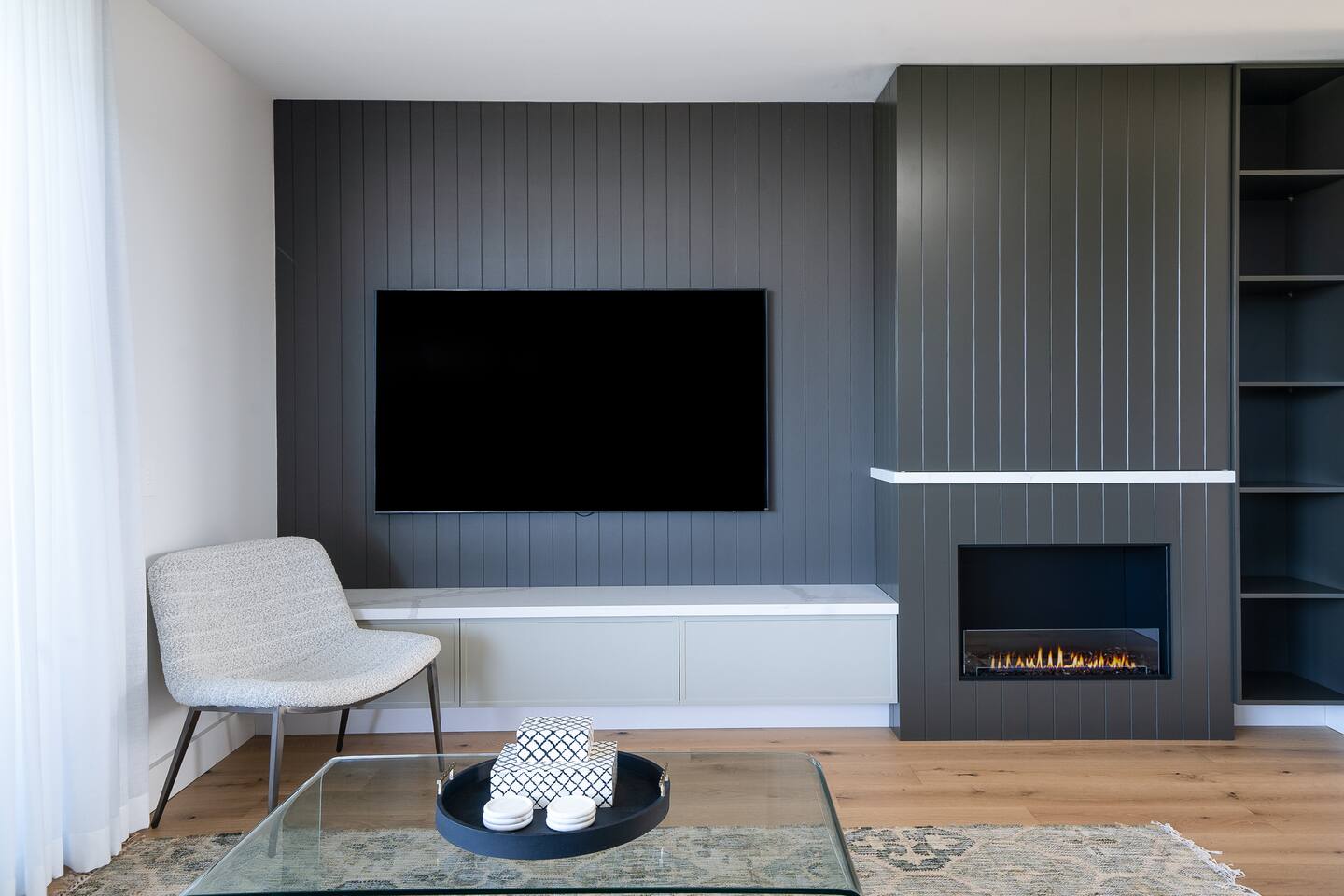 Living room with 75" Smart TV and fireplace