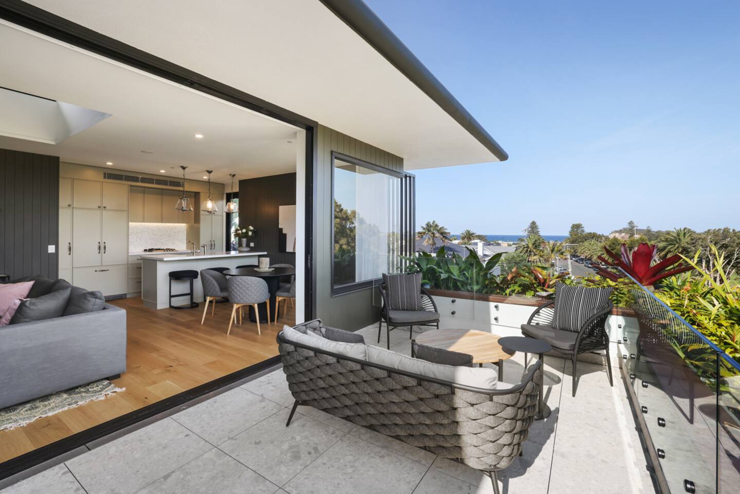 Large balcony with lounge and bar table.