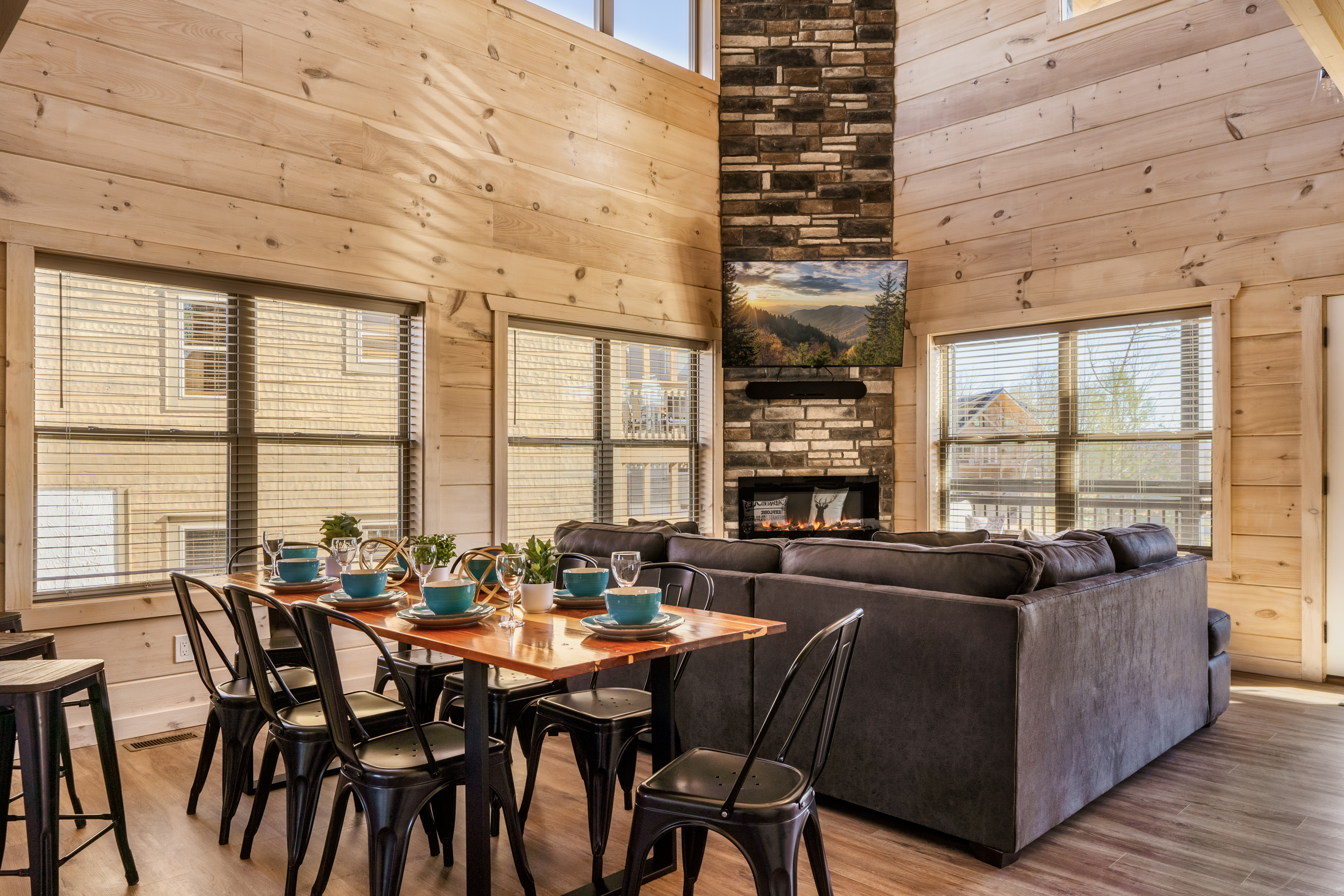 Bright great room with vaulted wood ceilings, fireplace, and dining for 6
