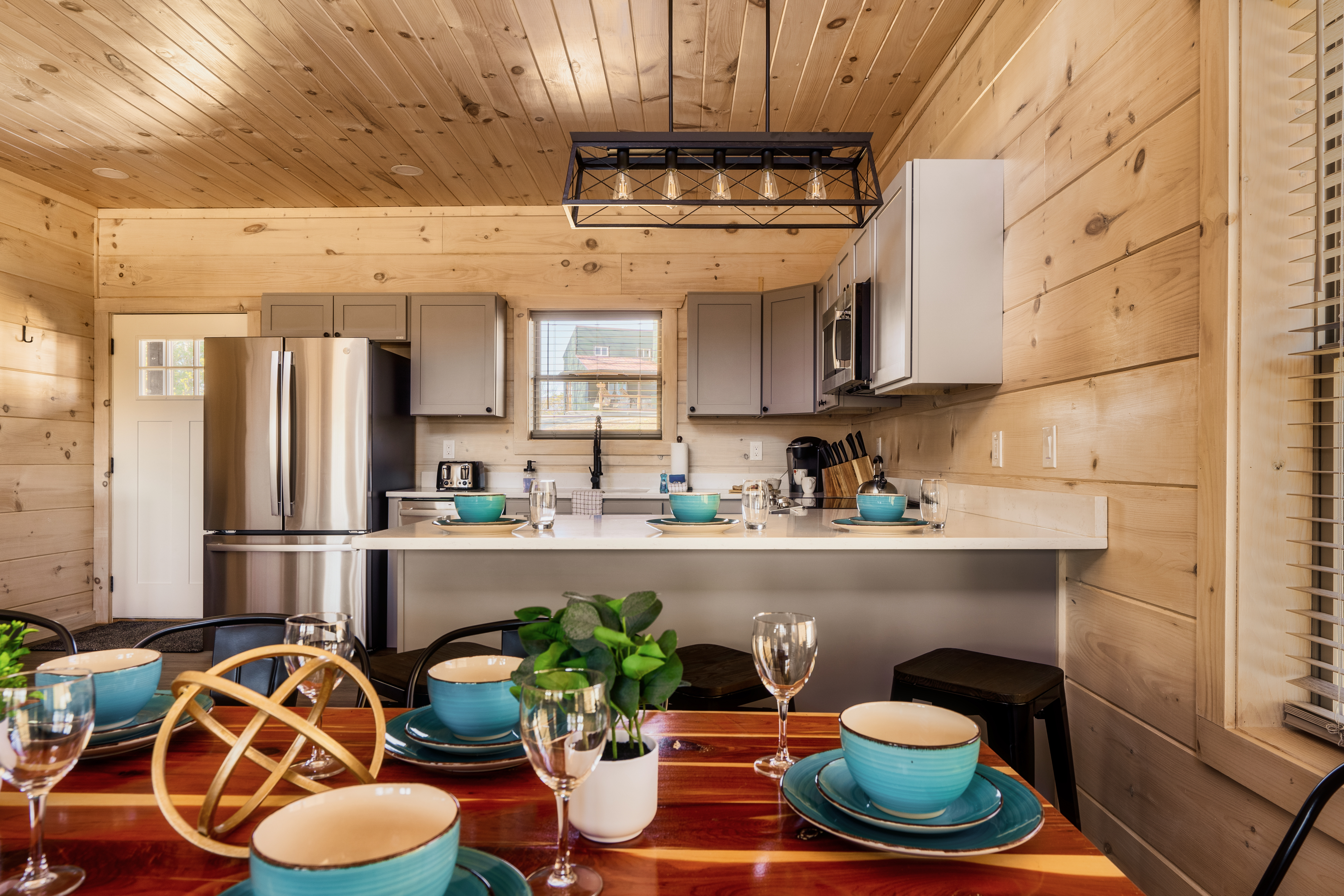 Cozy cabin kitchen with breakfast bar and dining space for gathering