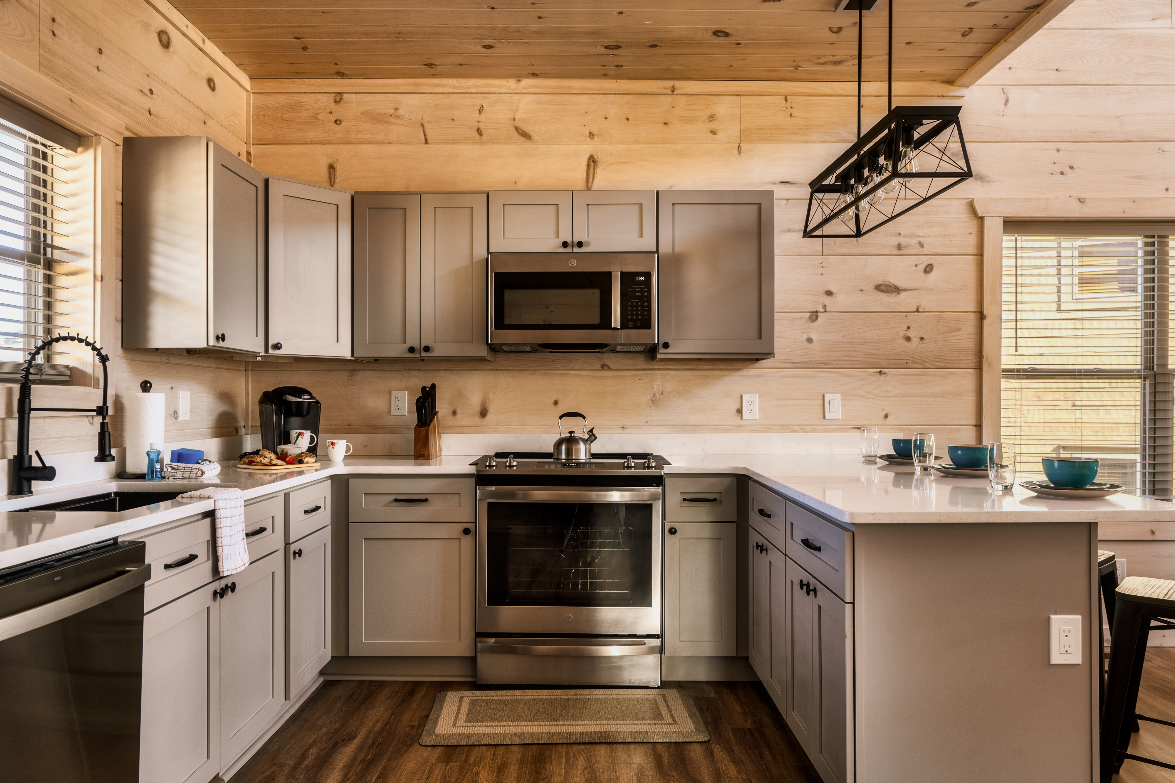 Modern cabin kitchen with breakfast bar, stainless appliances, and warm wood charm