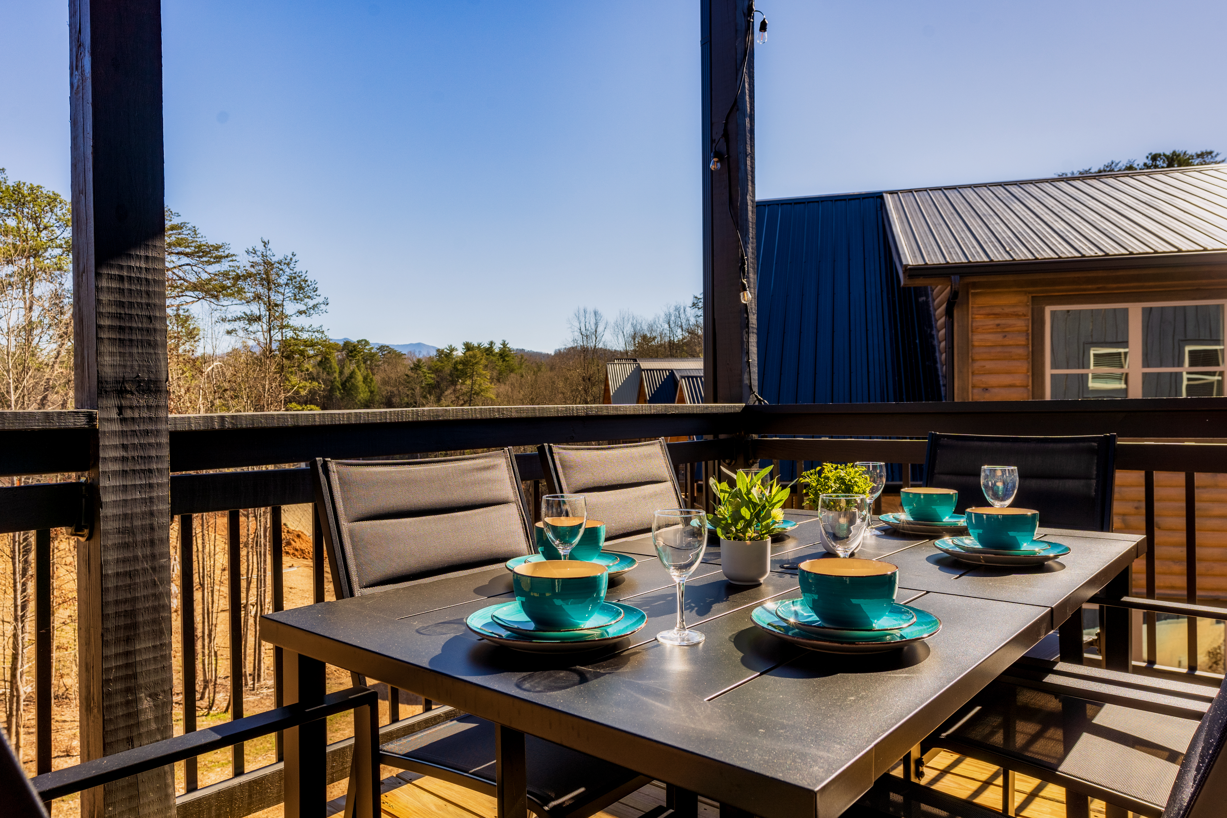 Covered mountain-view deck with stylish outdoor dining for six