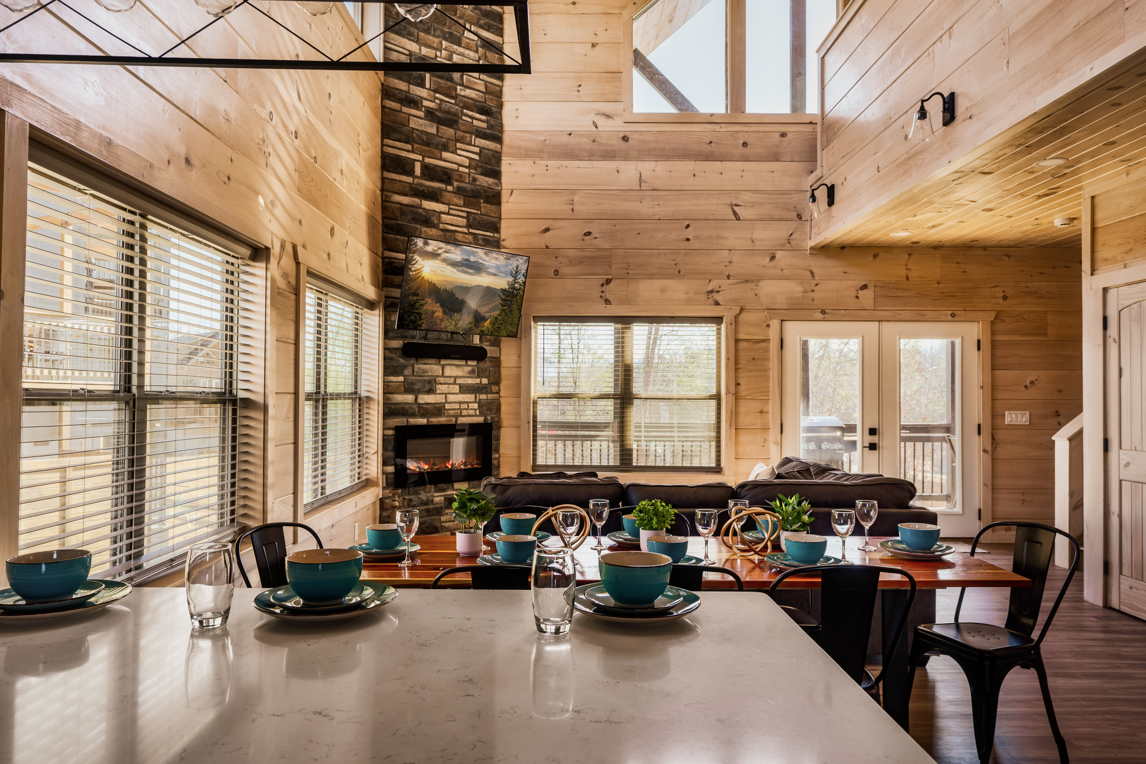 Bright open-concept cabin with stone fireplace and spacious dining area
