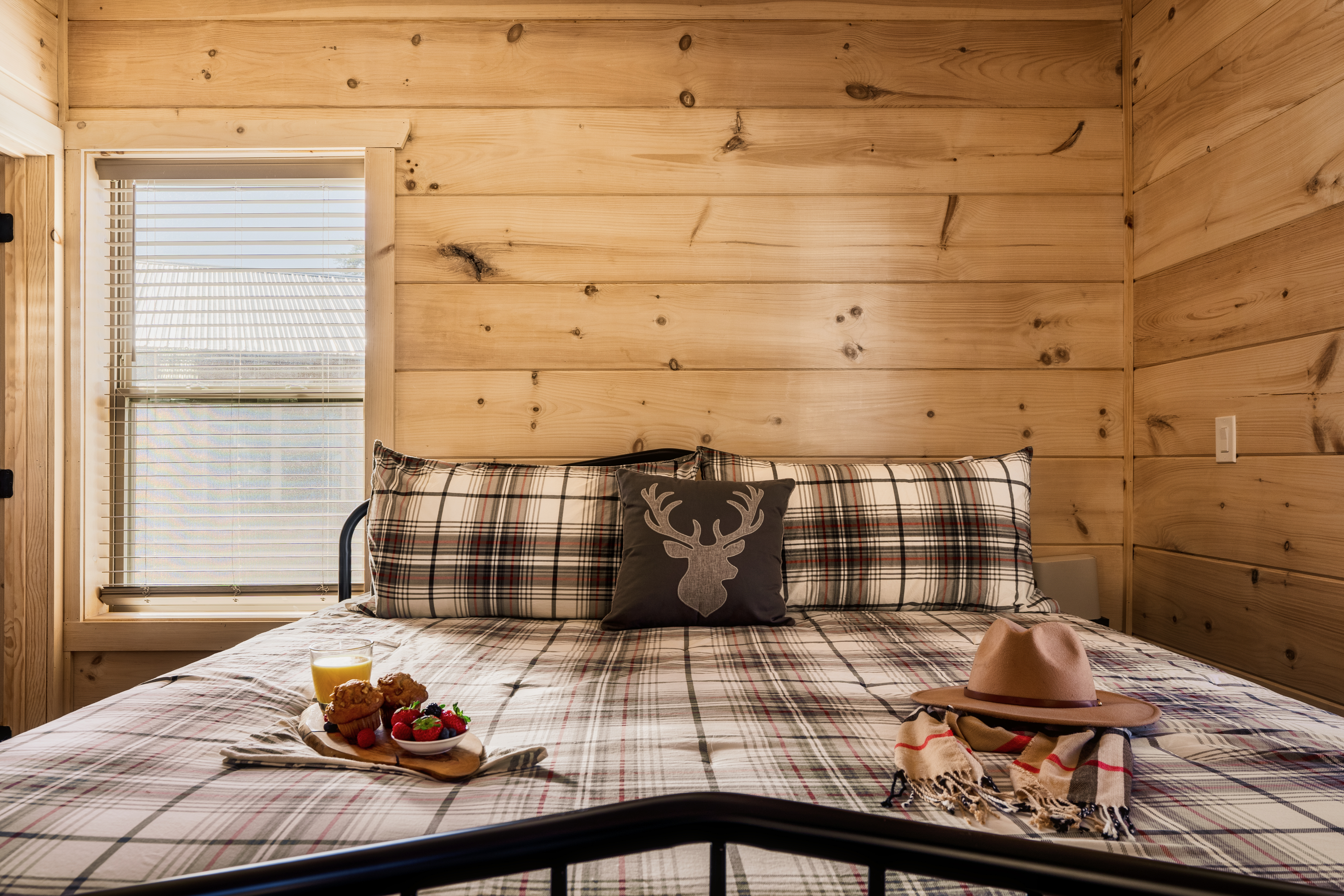 Cozy rustic bedroom with plaid bedding and warm cabin charm