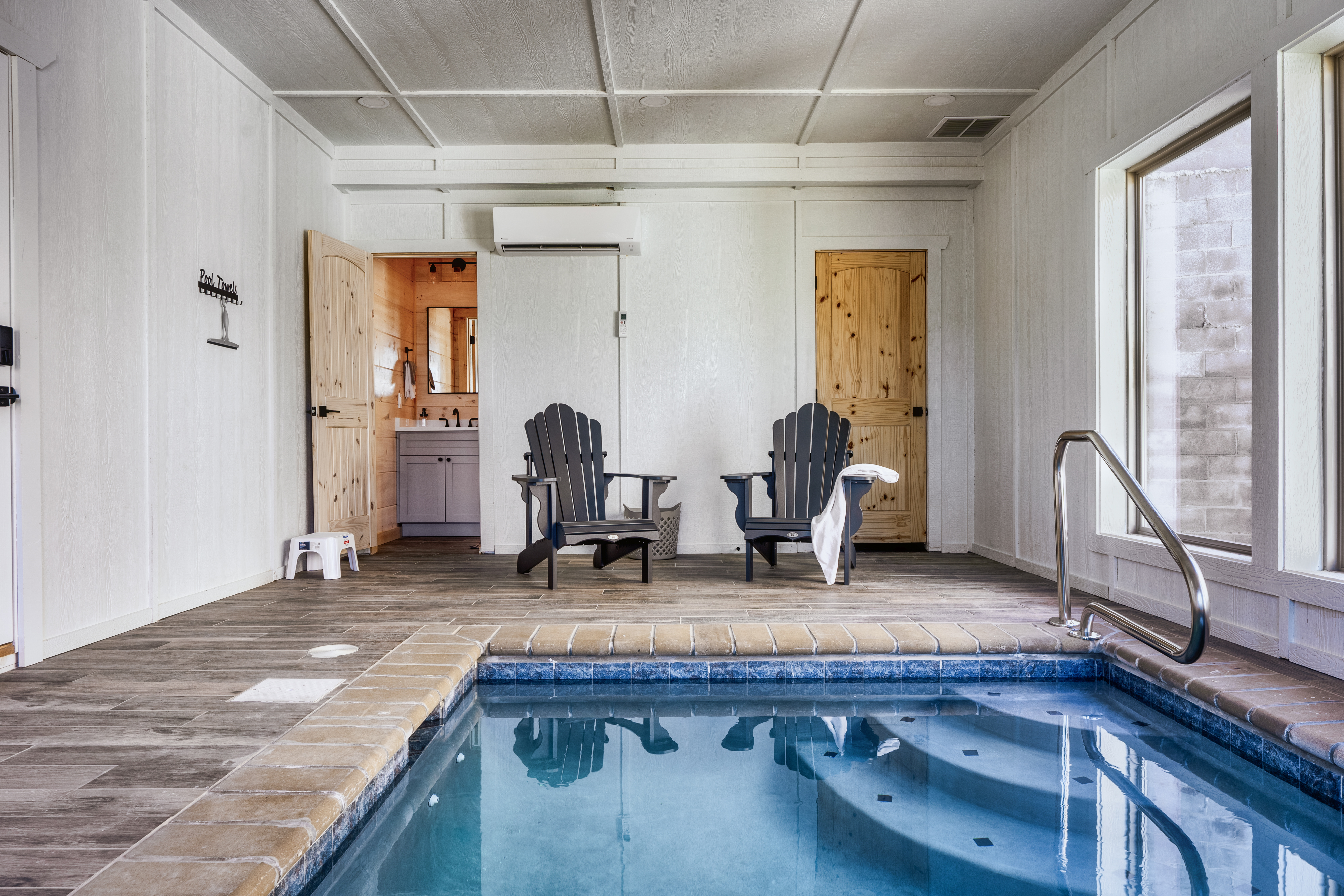 Private indoor pool with lounge seating and bright spa-like ambiance
