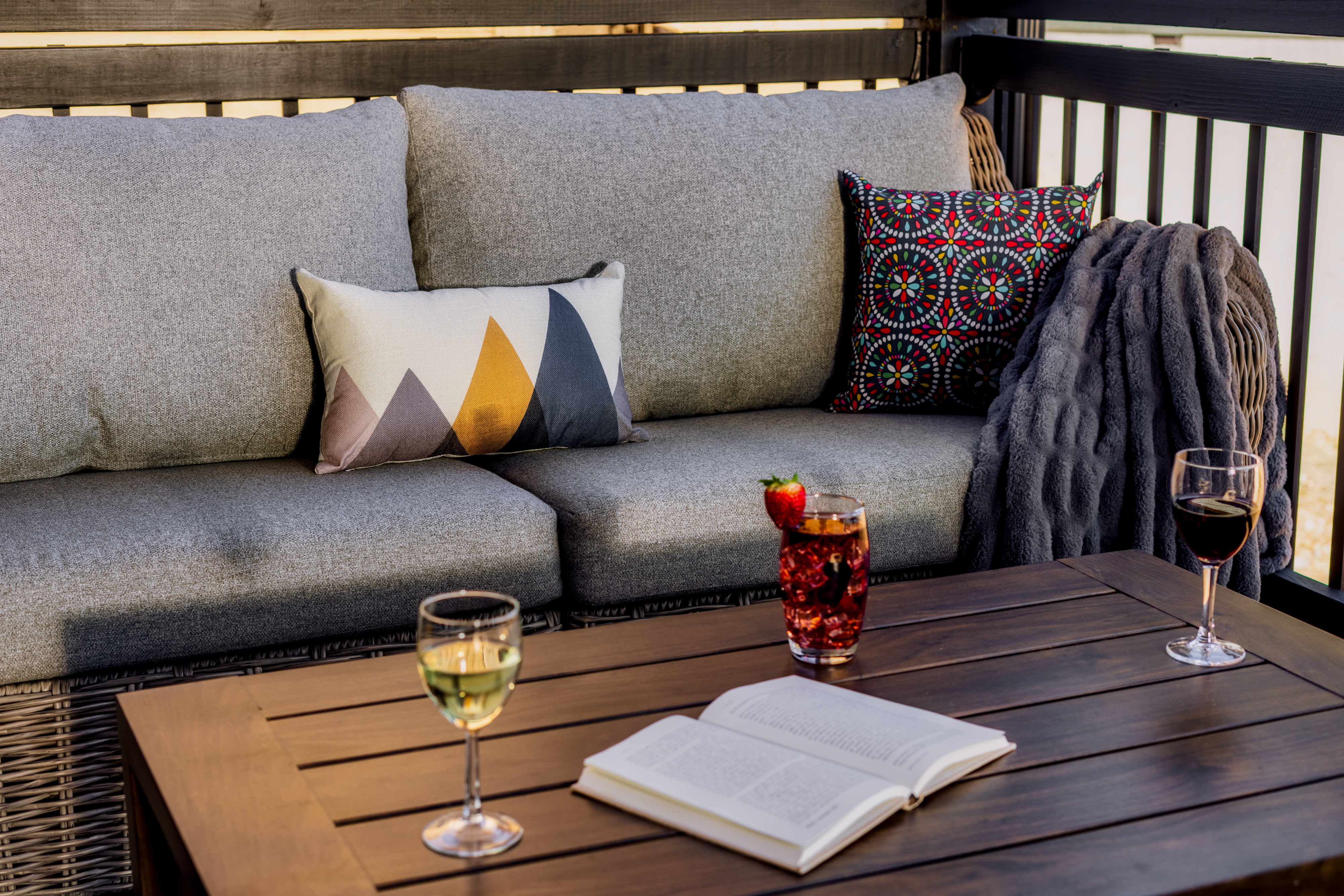 Cozy outdoor lounge with plush seating, wine, and a perfect spot to unwind