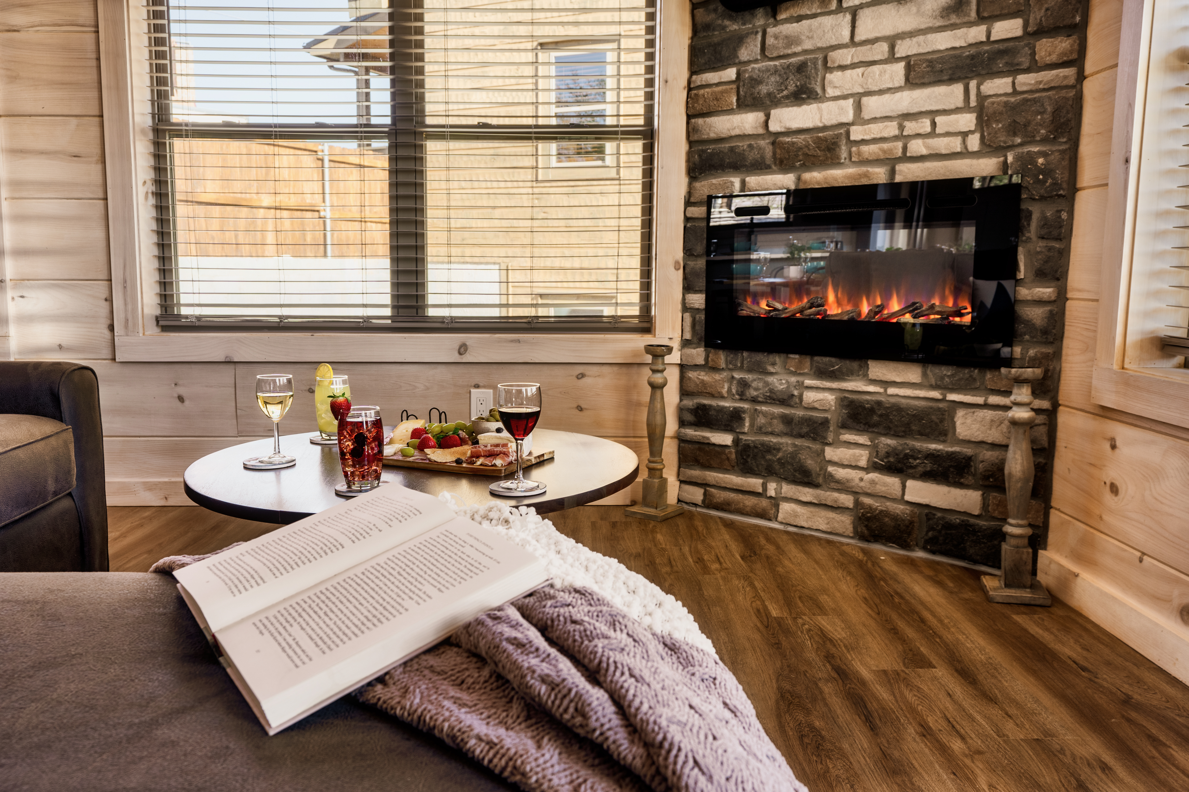 Cozy fireplace lounge with wine, charcuterie, and rustic cabin charm