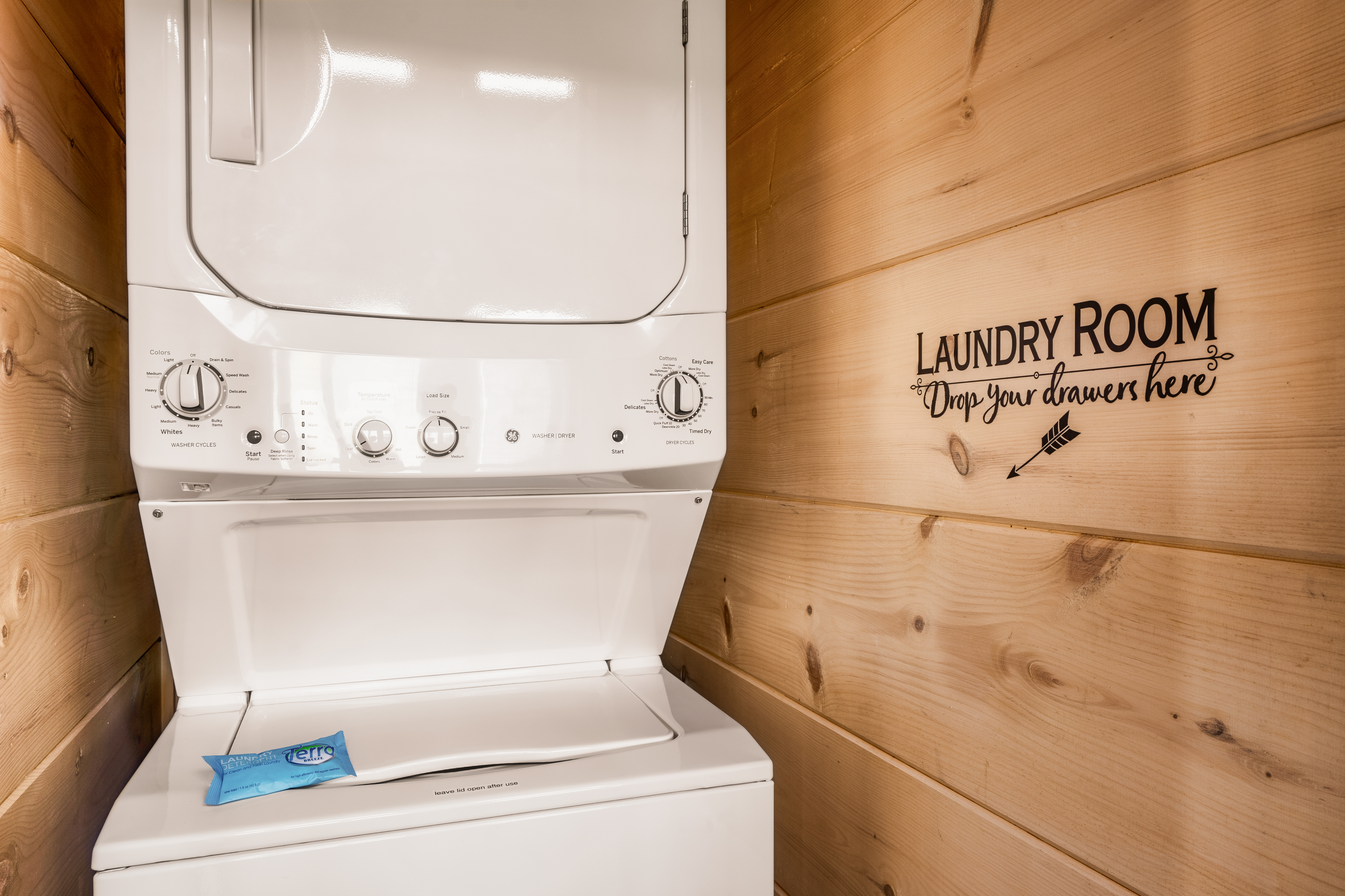 Private stacked washer/dryer in a cozy, cabin-style laundry nook