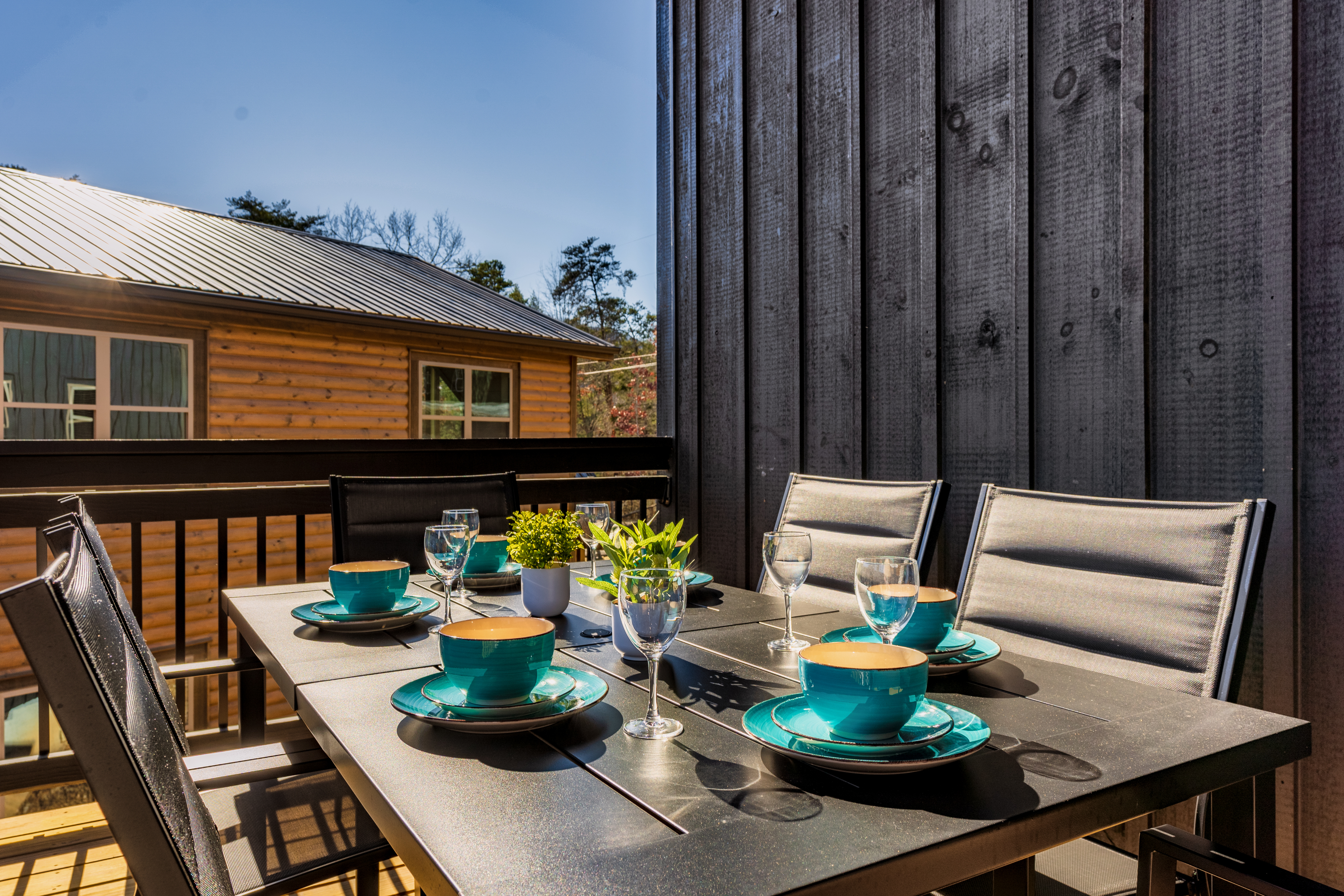 Sunny private balcony with stylish outdoor dining for four