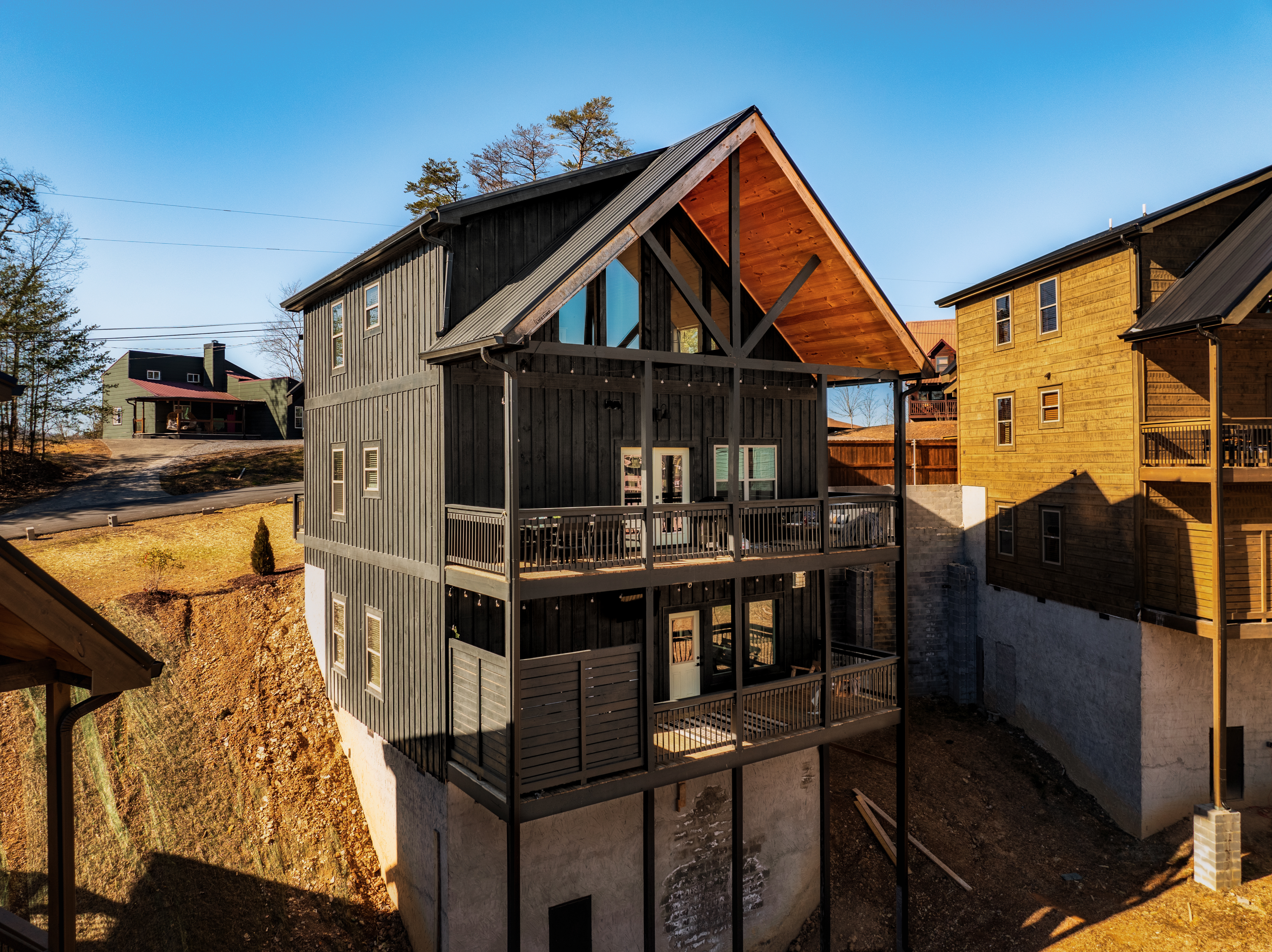 Modern mountain cabin with covered balconies and striking wood accents
