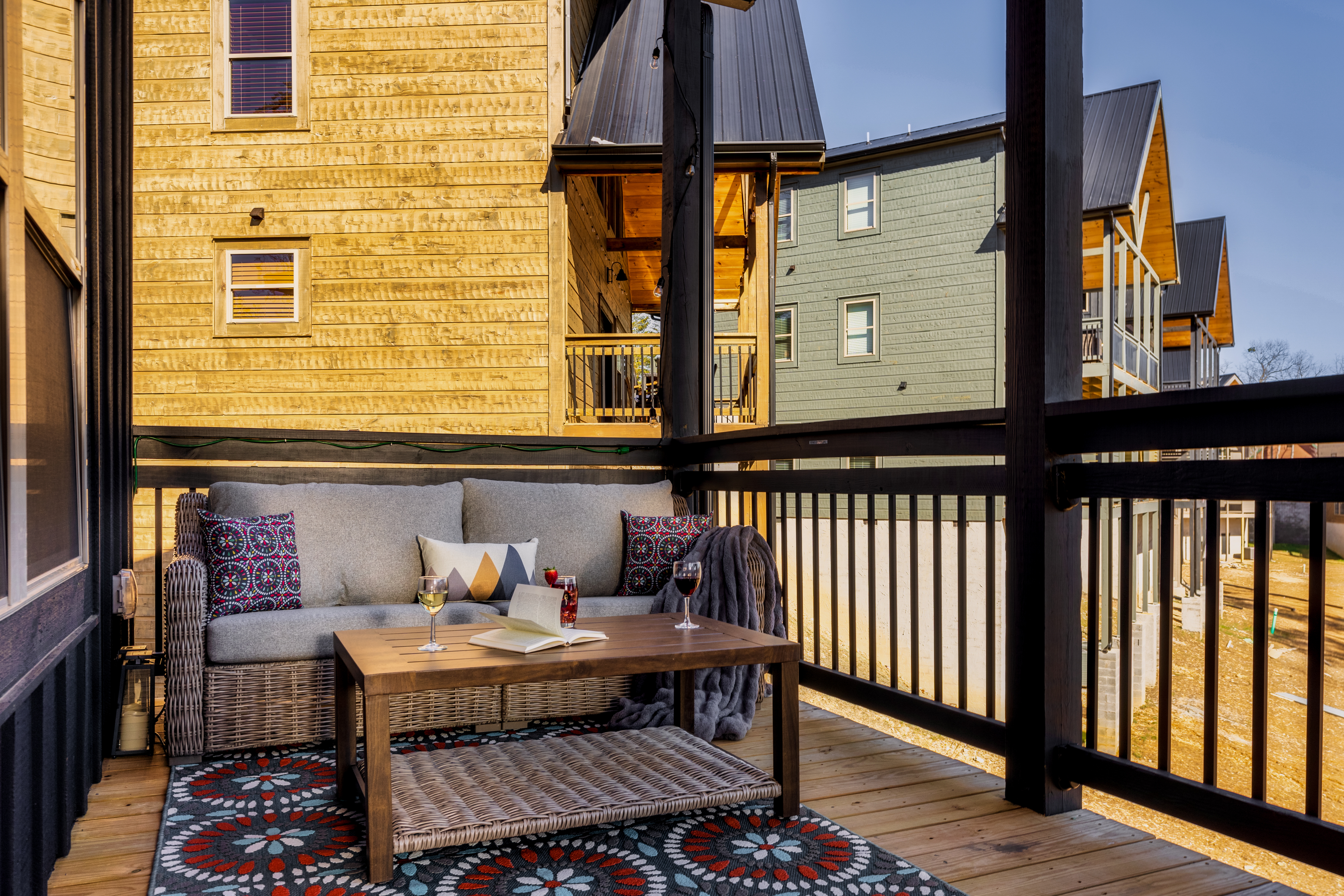 Cozy covered balcony with lounge seating for coffee or evening wine