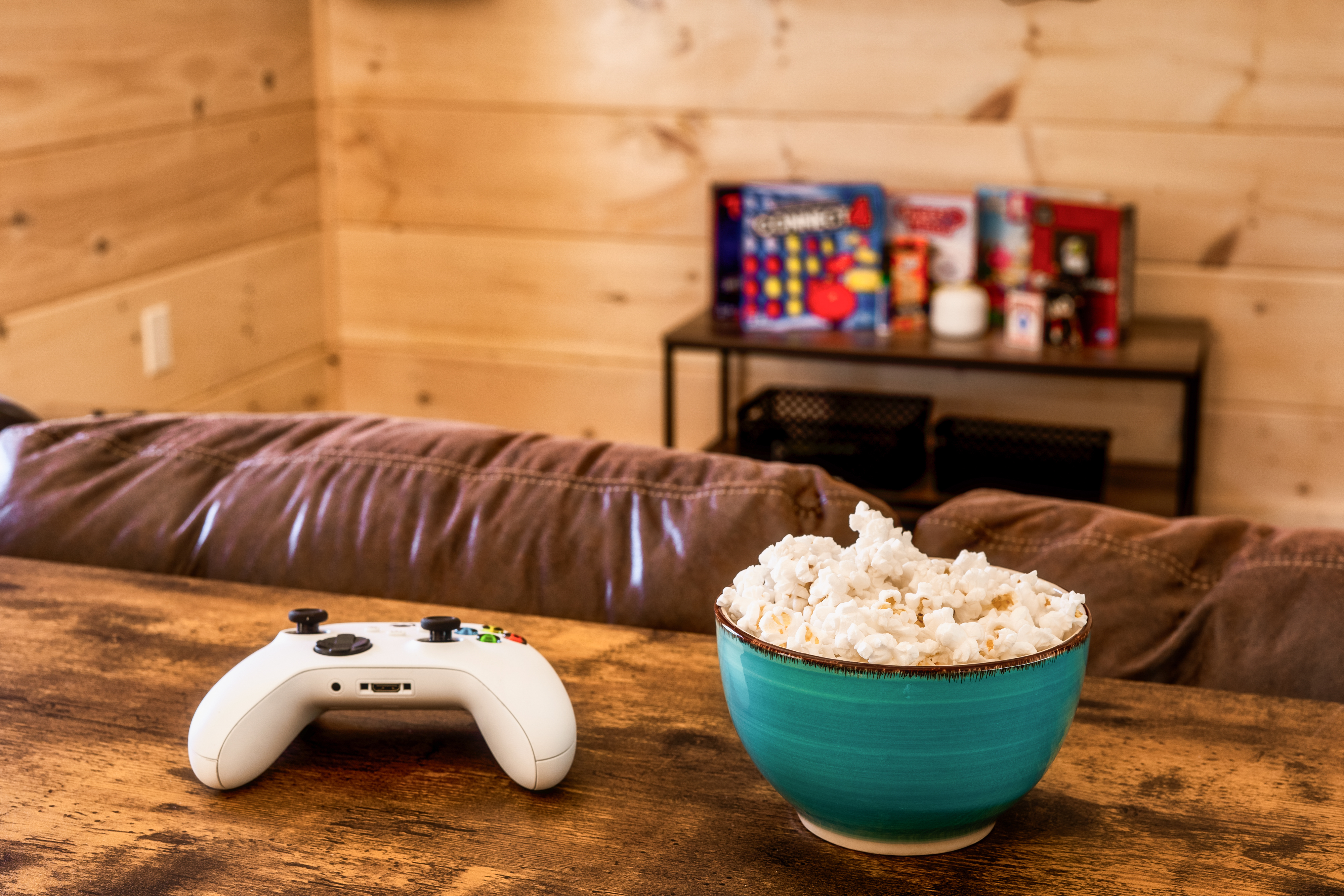 Cozy game and movie night setup with popcorn, console gaming, and board games