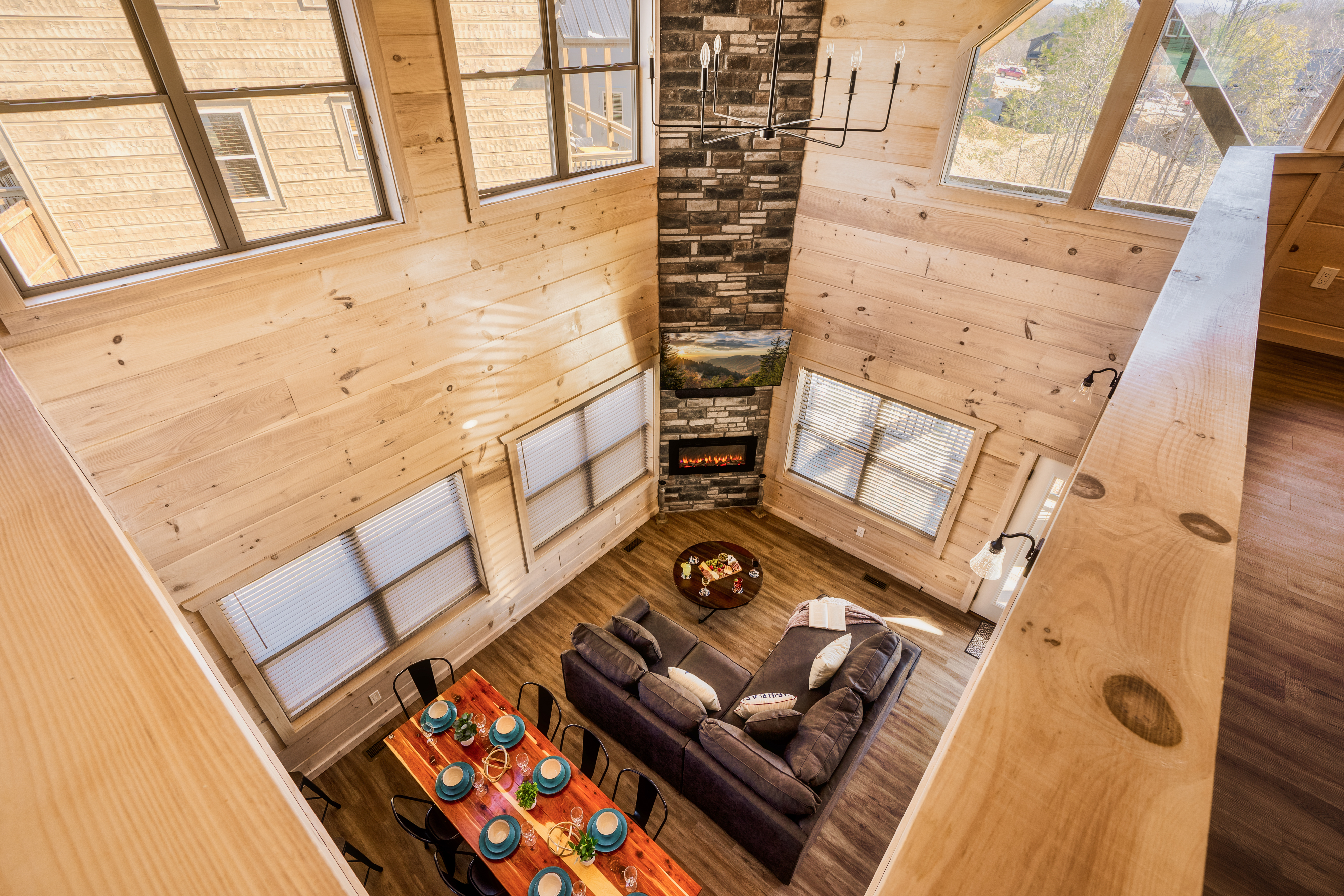 Soaring ceilings, stone fireplace, and a bright open living space