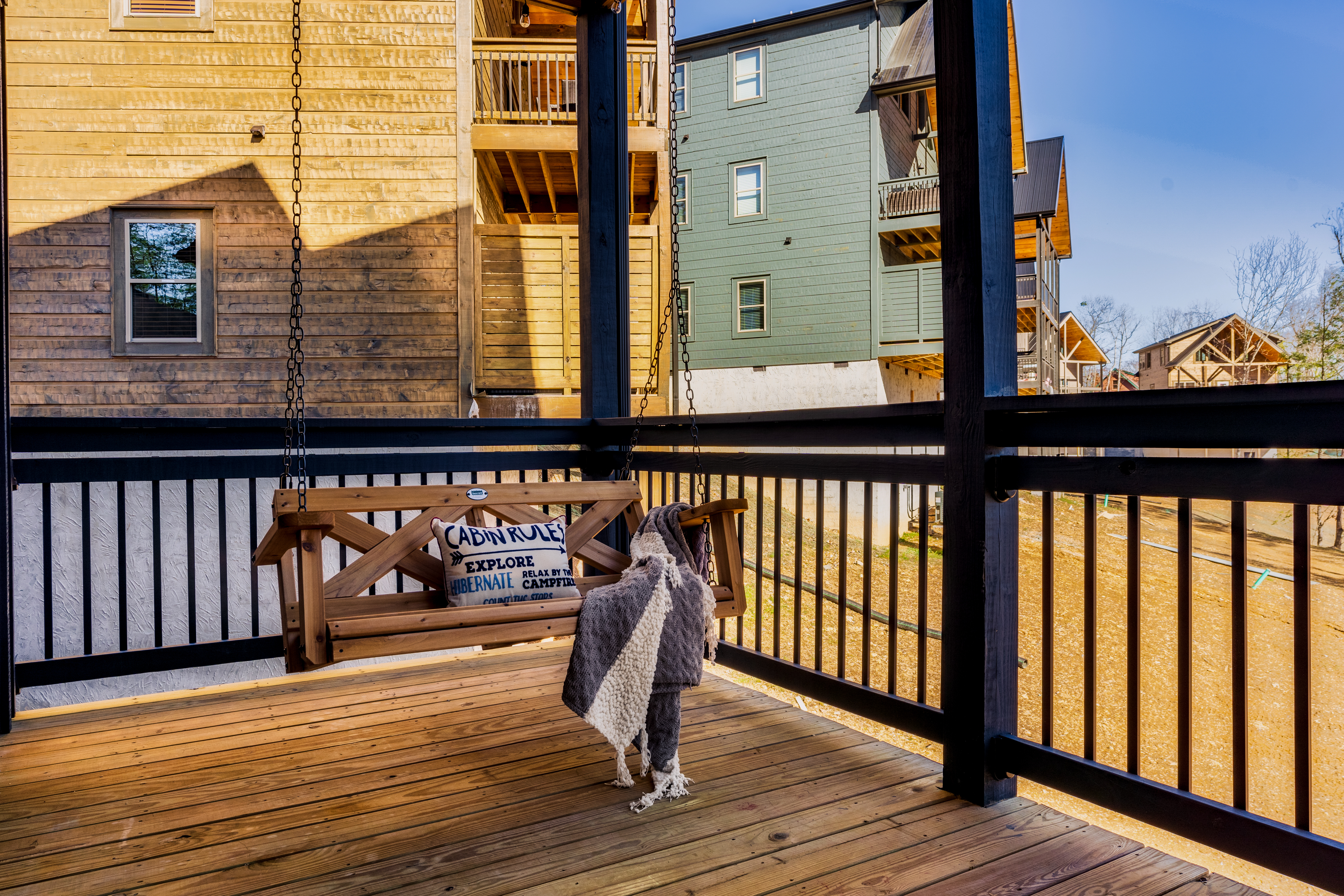 Cozy covered deck with porch swing and inviting cabin-style charm