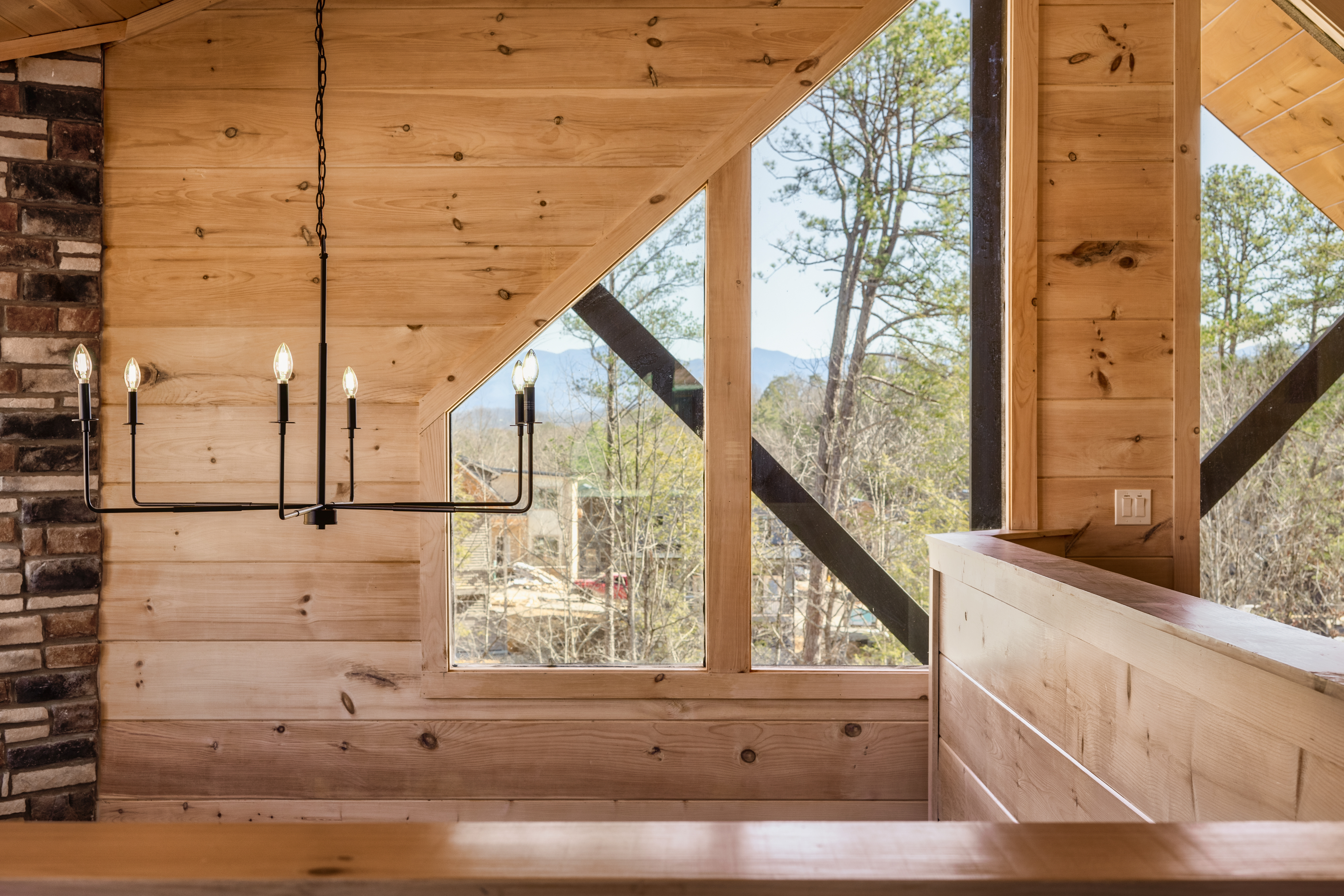 Rustic wood interior with soaring windows and serene mountain views