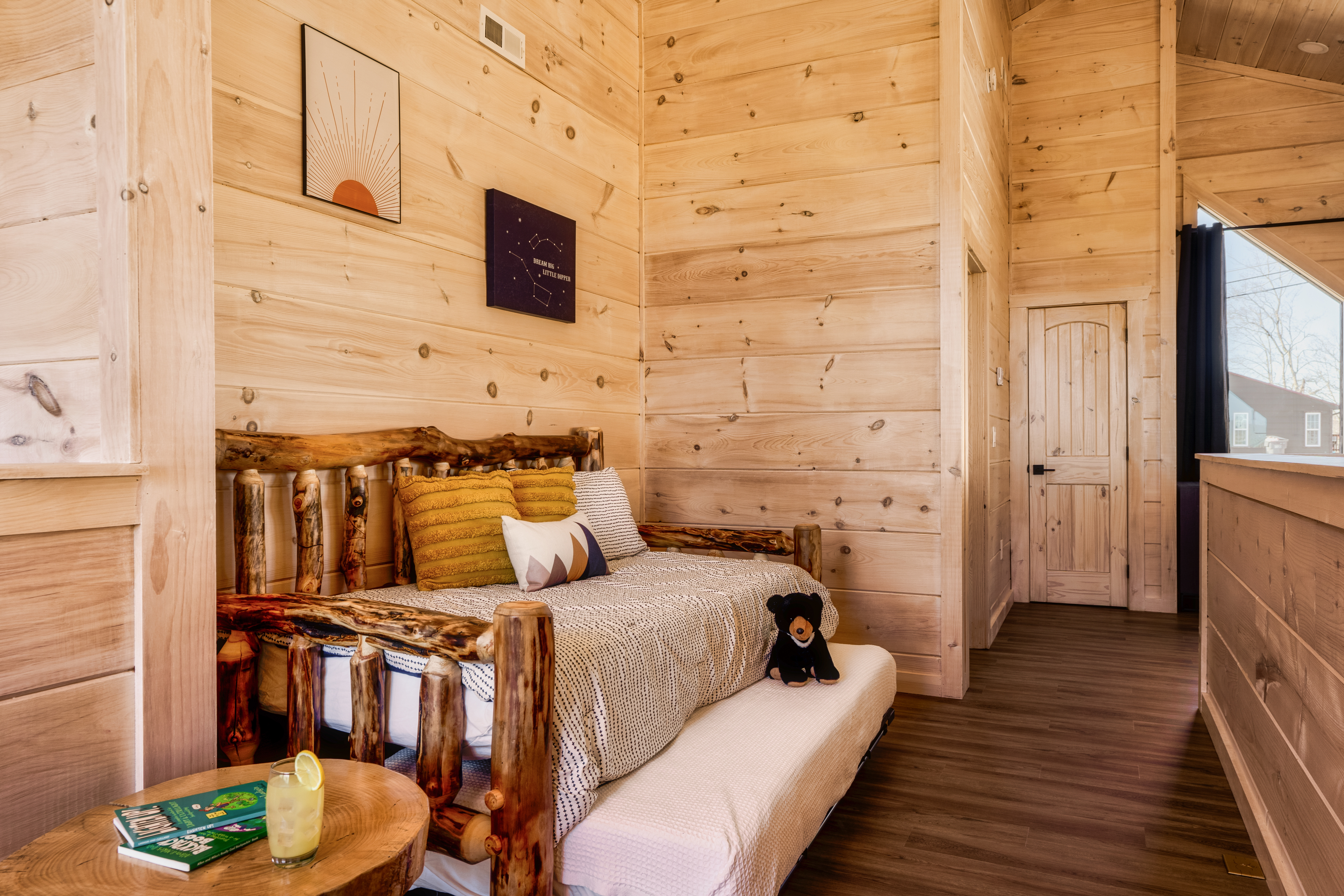 Cozy loft nook with rustic log daybed and warm cabin charm