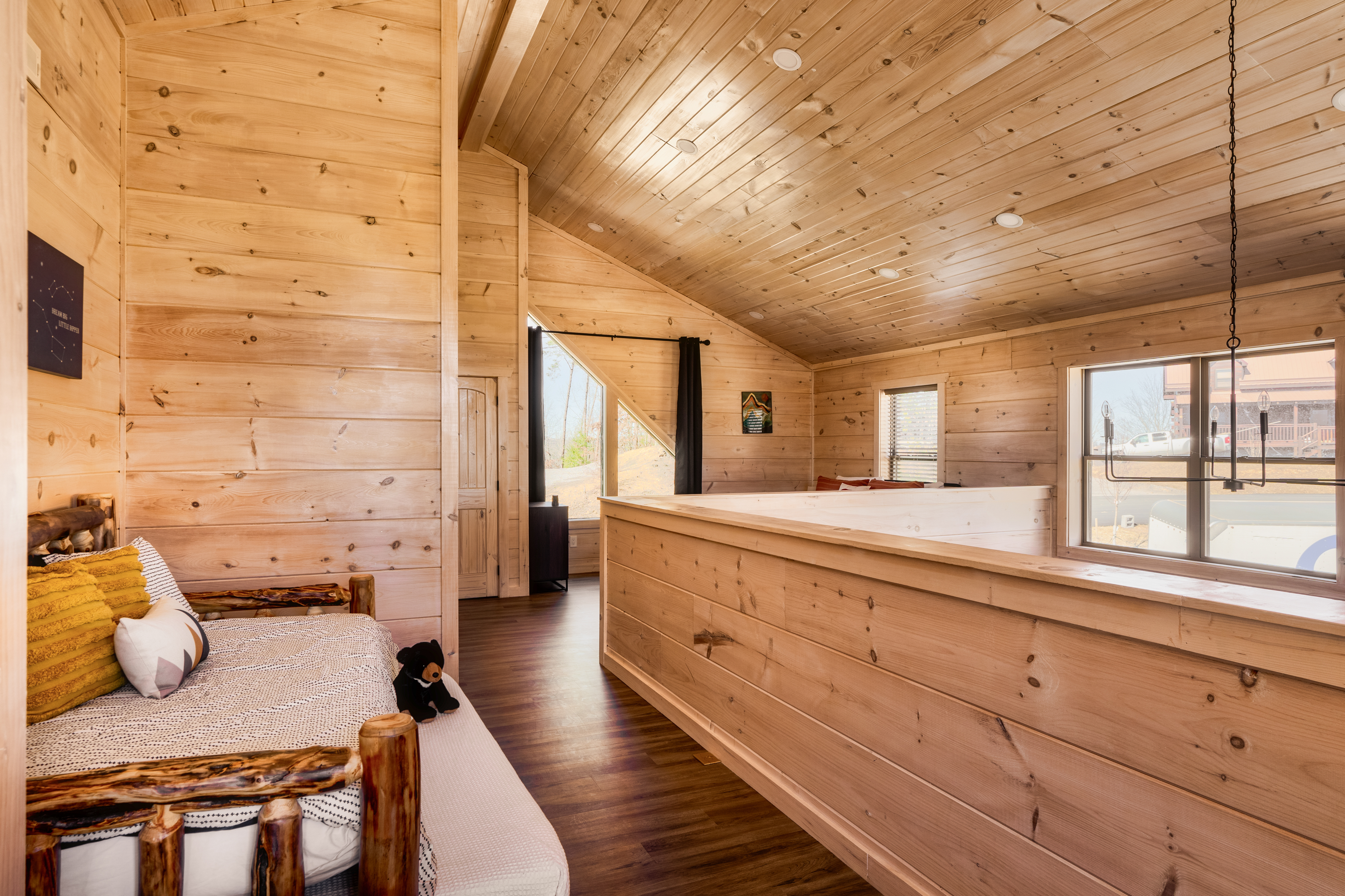 Cozy rustic loft with vaulted wood ceilings and sunny cabin charm