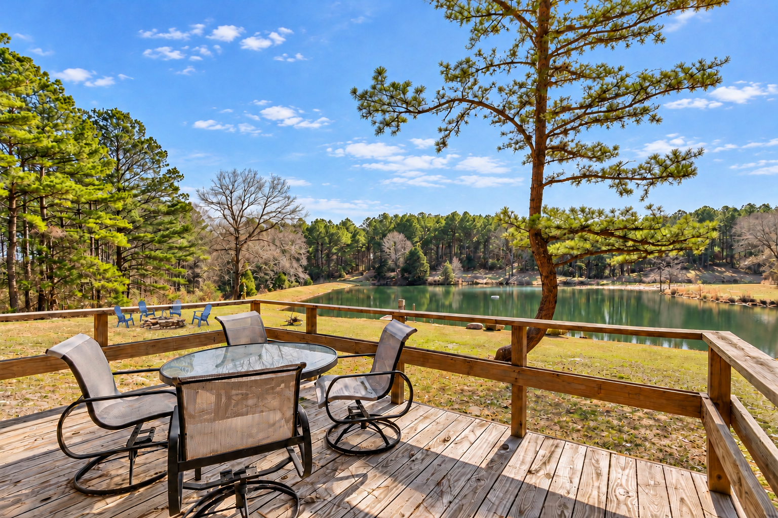 Private lakeside deck with dining set, fire pit, and serene water views