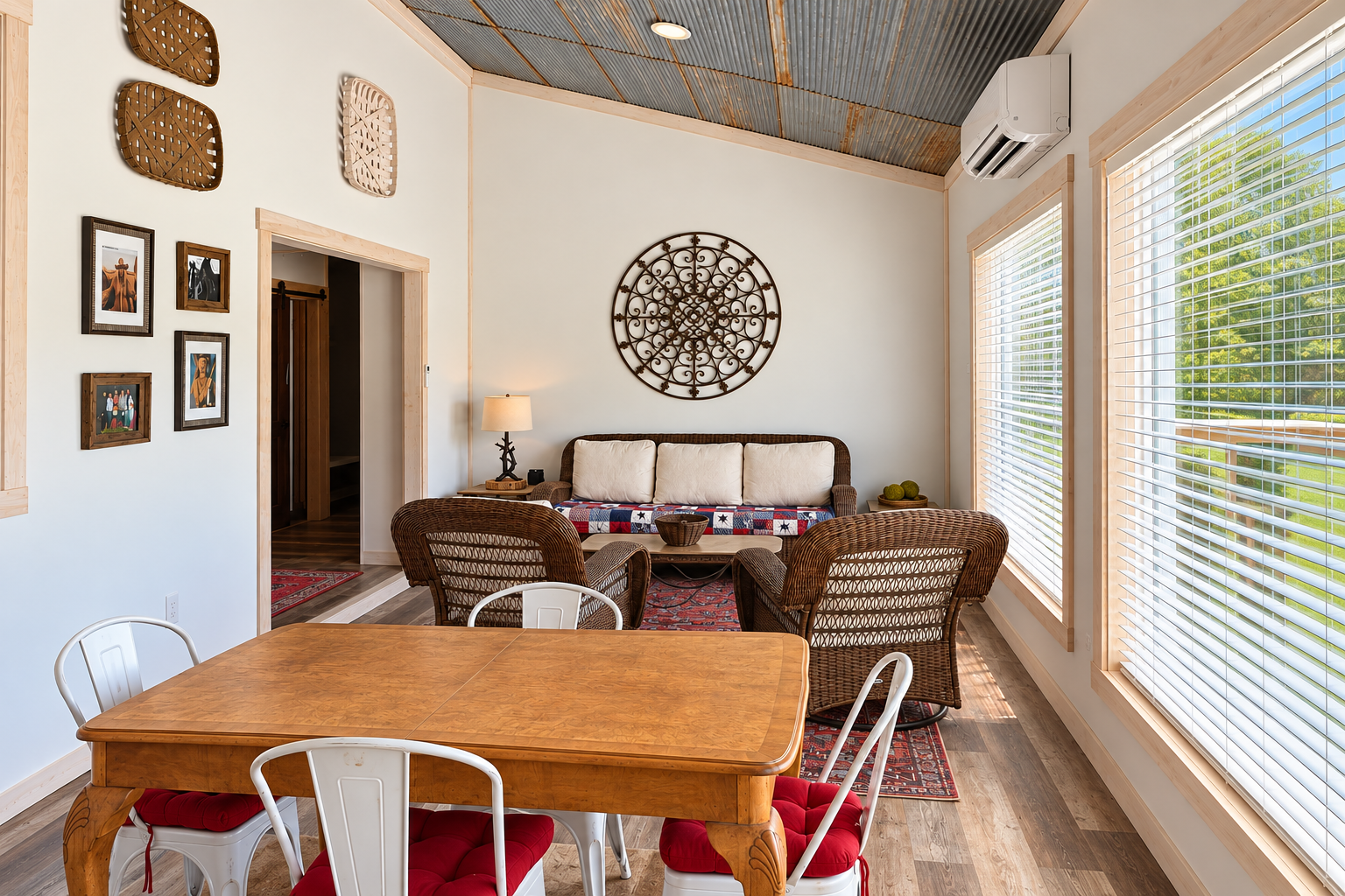 Bright rustic lounge with big windows, dining space, and cozy seating