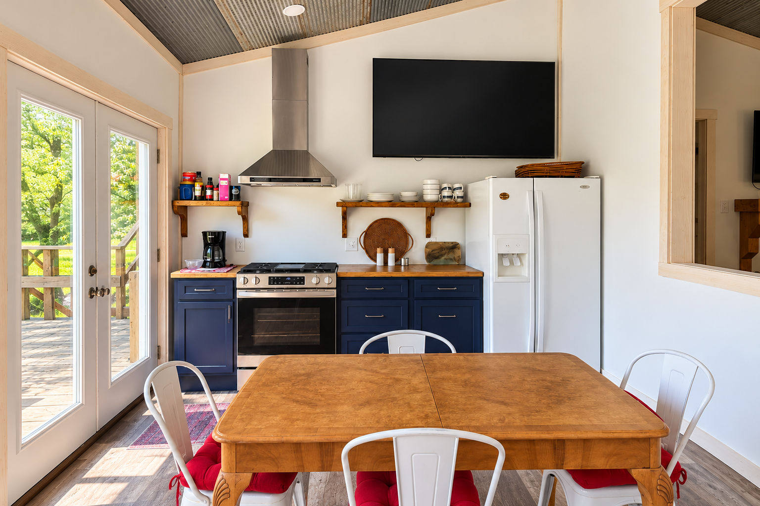 Bright kitchenette with dining for 4, big TV, and deck access