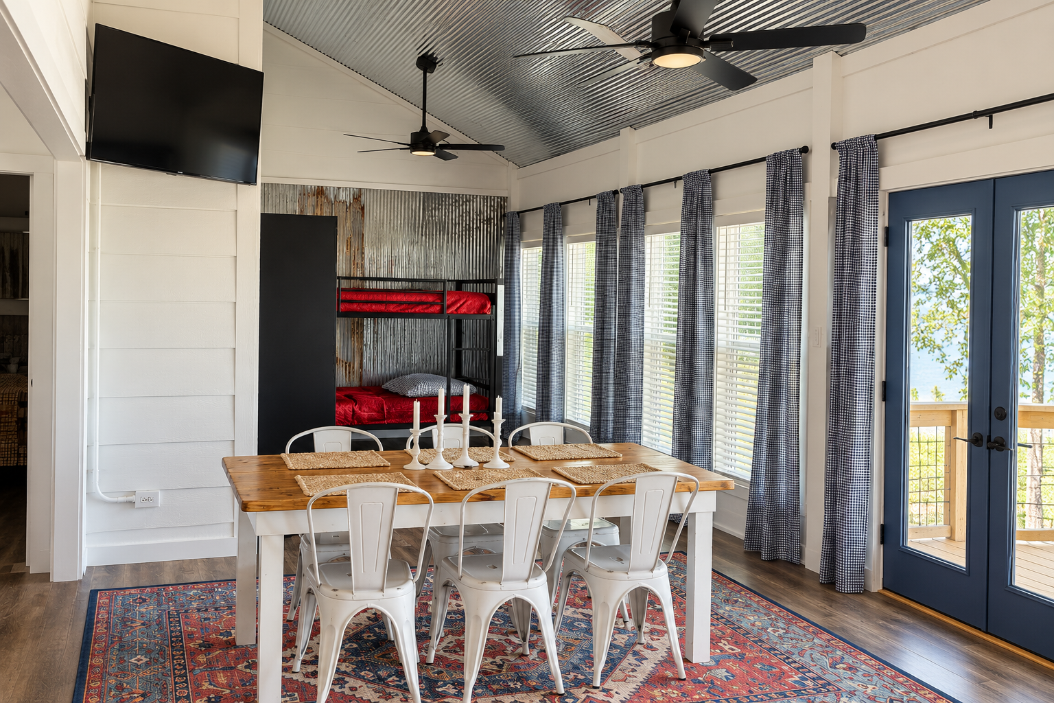 Bright rustic-modern dining space with bunk nook, TV, and outdoor access