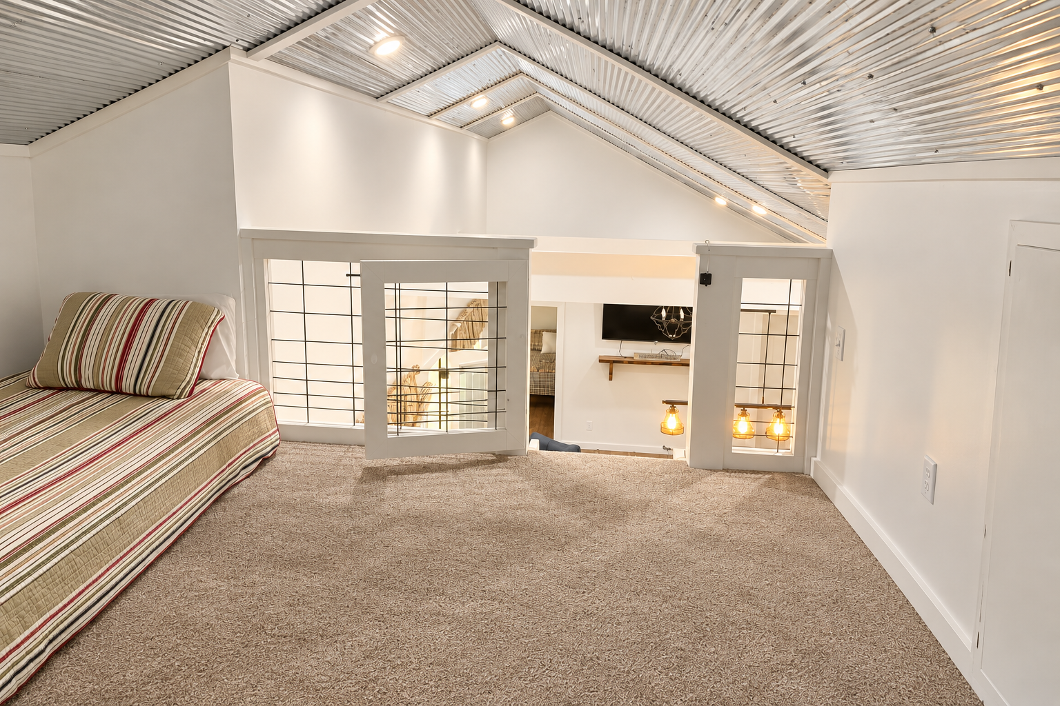 Cozy carpeted loft with built-in bed and stylish modern-rustic ceiling