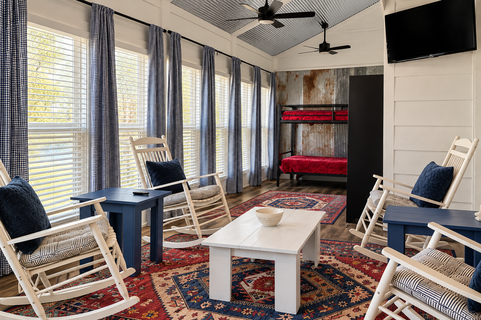Bright lounge with rocking chairs, tall windows, and rustic bunk beds