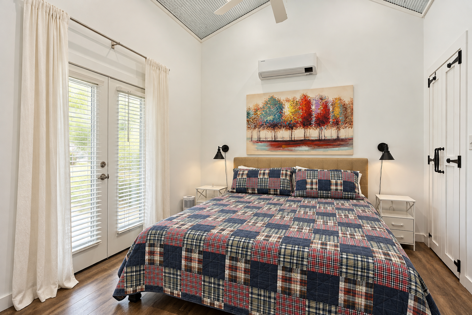 Bright, cozy bedroom with high ceilings, natural light, and stylish touches
