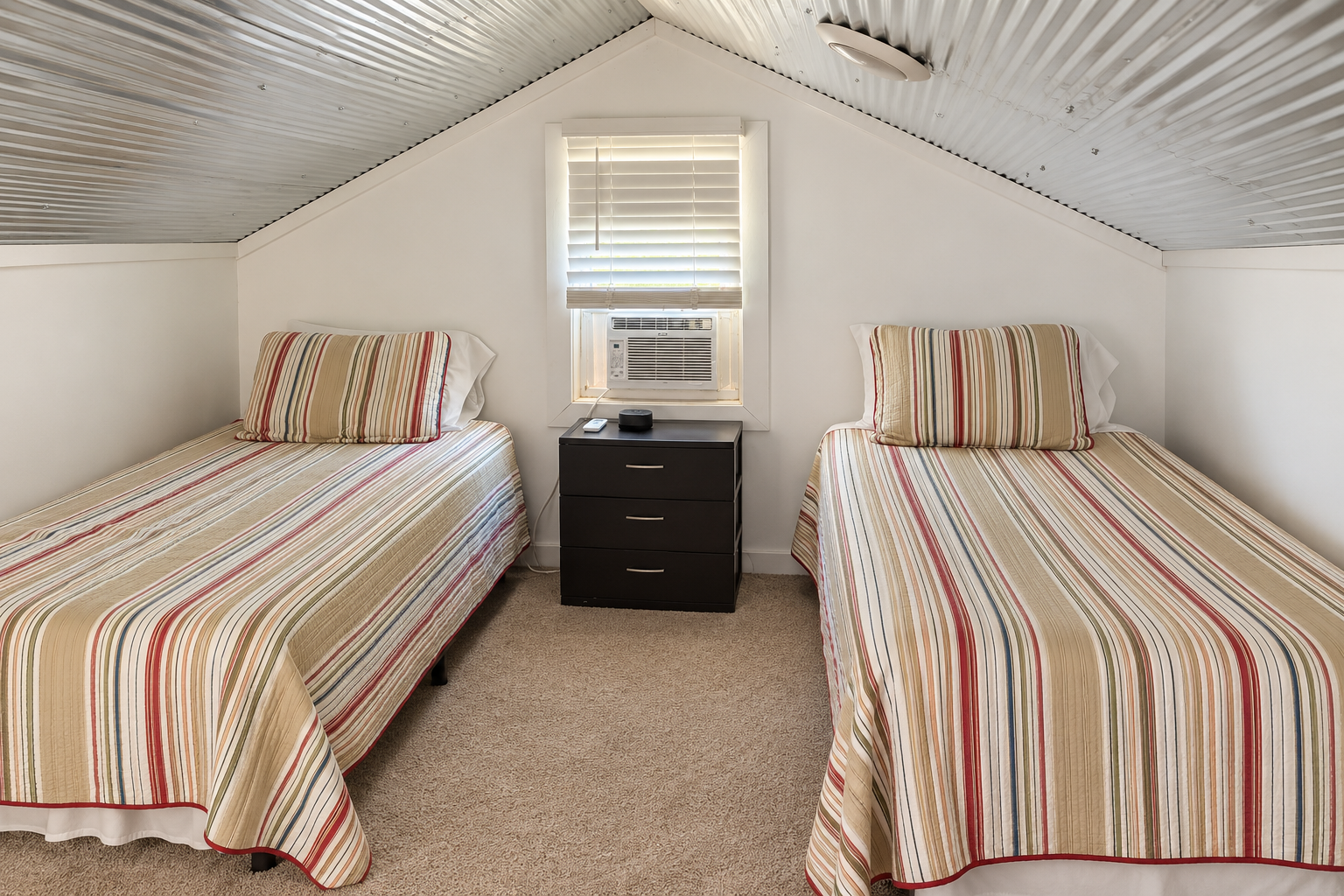 Cozy loft room with two twin beds—perfect for kids or extra guests