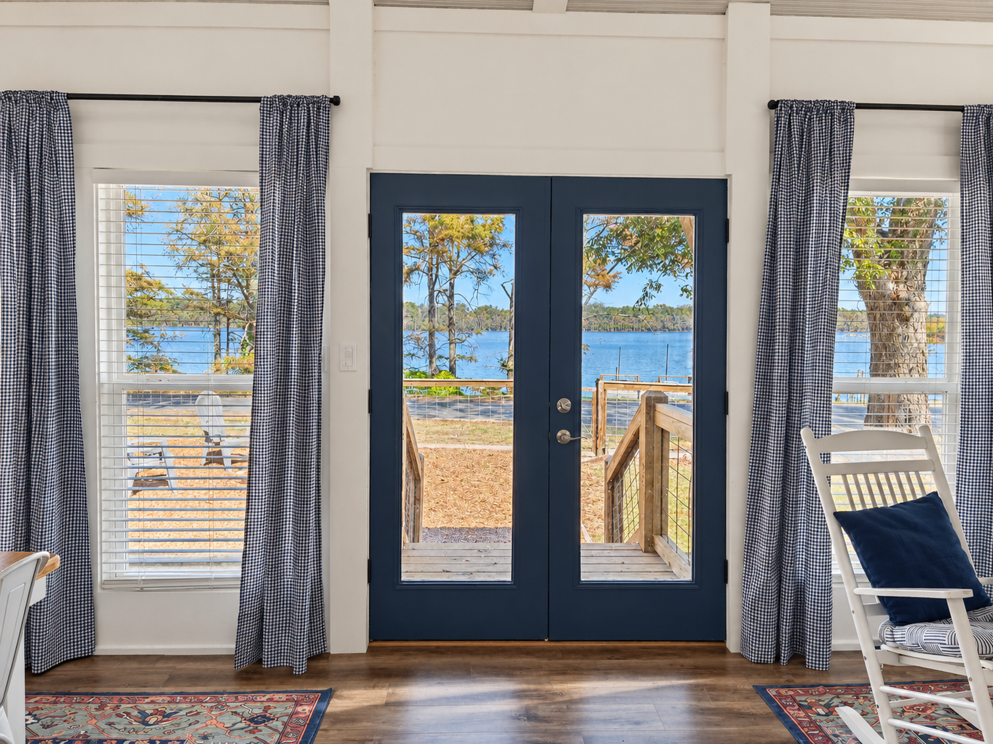 Bright lakefront entry with French doors and serene water views