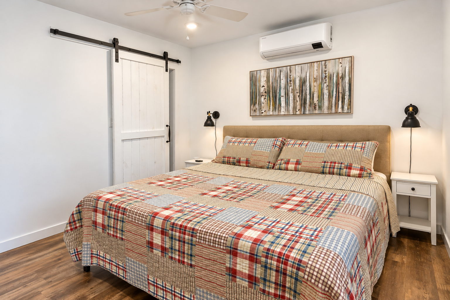 Cozy rustic bedroom with barn door, AC, and plush king bed