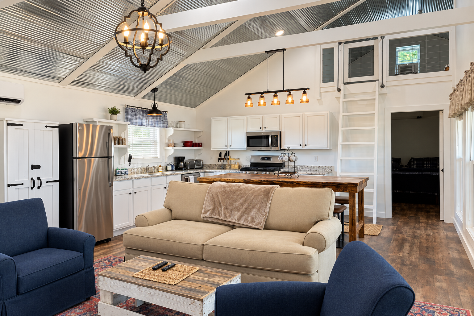 Bright modern farmhouse living space with loft, island, and vaulted ceiling