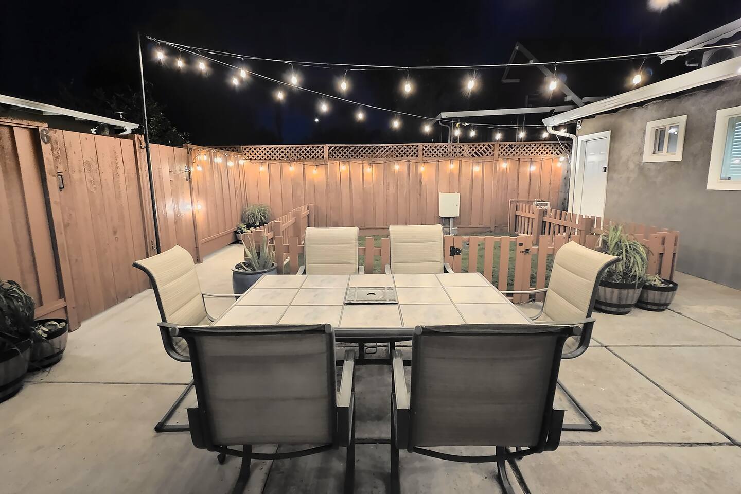 Shared backyard with string lights, shared with guests of the back units