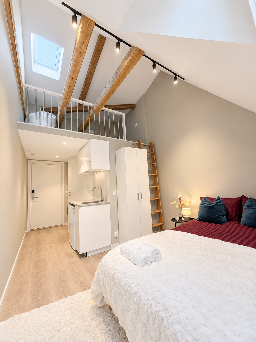 Bright loft studio with skylight, beams, kitchenette & cozy sleeping nook